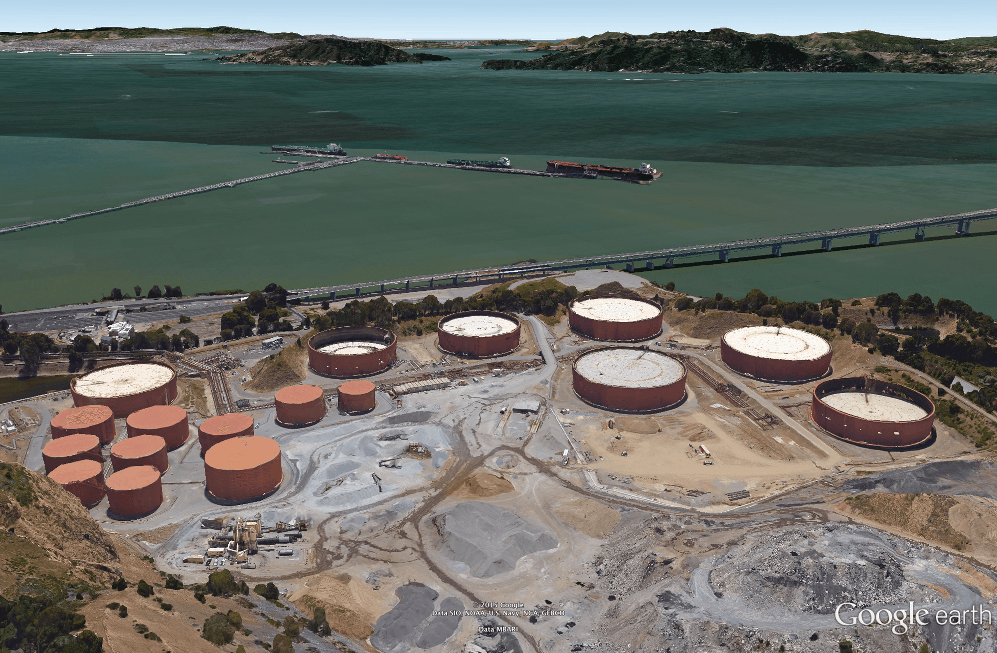 Section of the Chevron Richmond Refinery. These tanks are used to store crude oil offloaded from oil tankers. the tanks on the right are the ersatz 747 hangars.