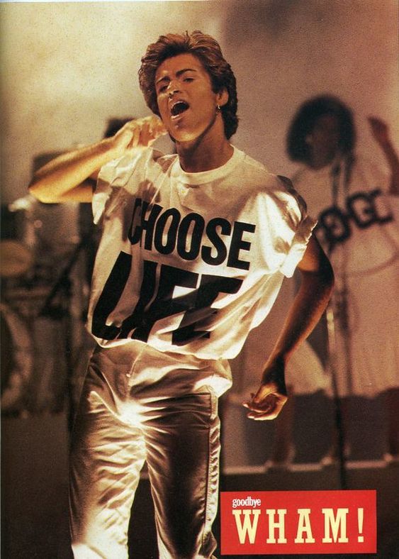 A young George Michael wearing Katherine Hamnett’s “Choose Life” shirt