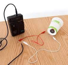 A camera and a cup with wires Description automatically generated with medium confidence