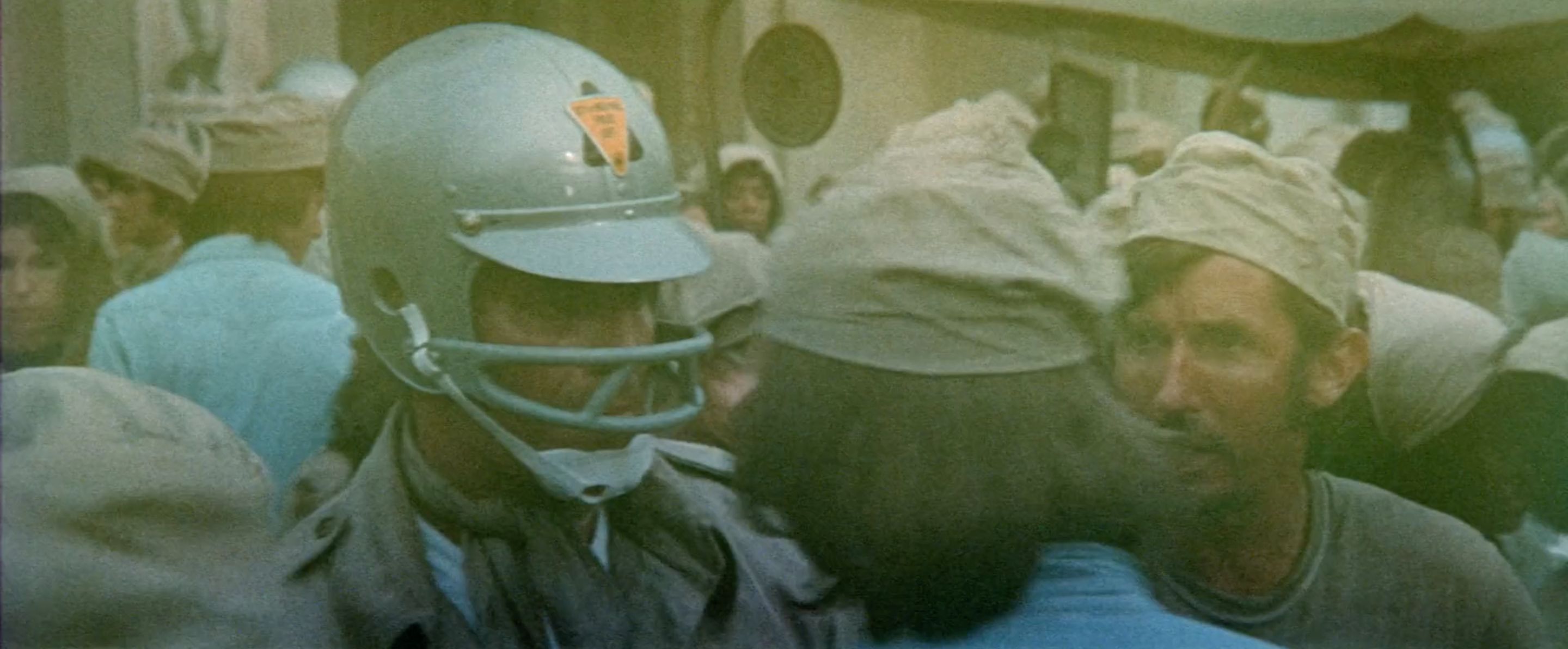 Here’s a bit of unexplained worldbuilding. Why do the police wear modified football helmets? I don’t know and I don’t want to know. Accept the mystery.