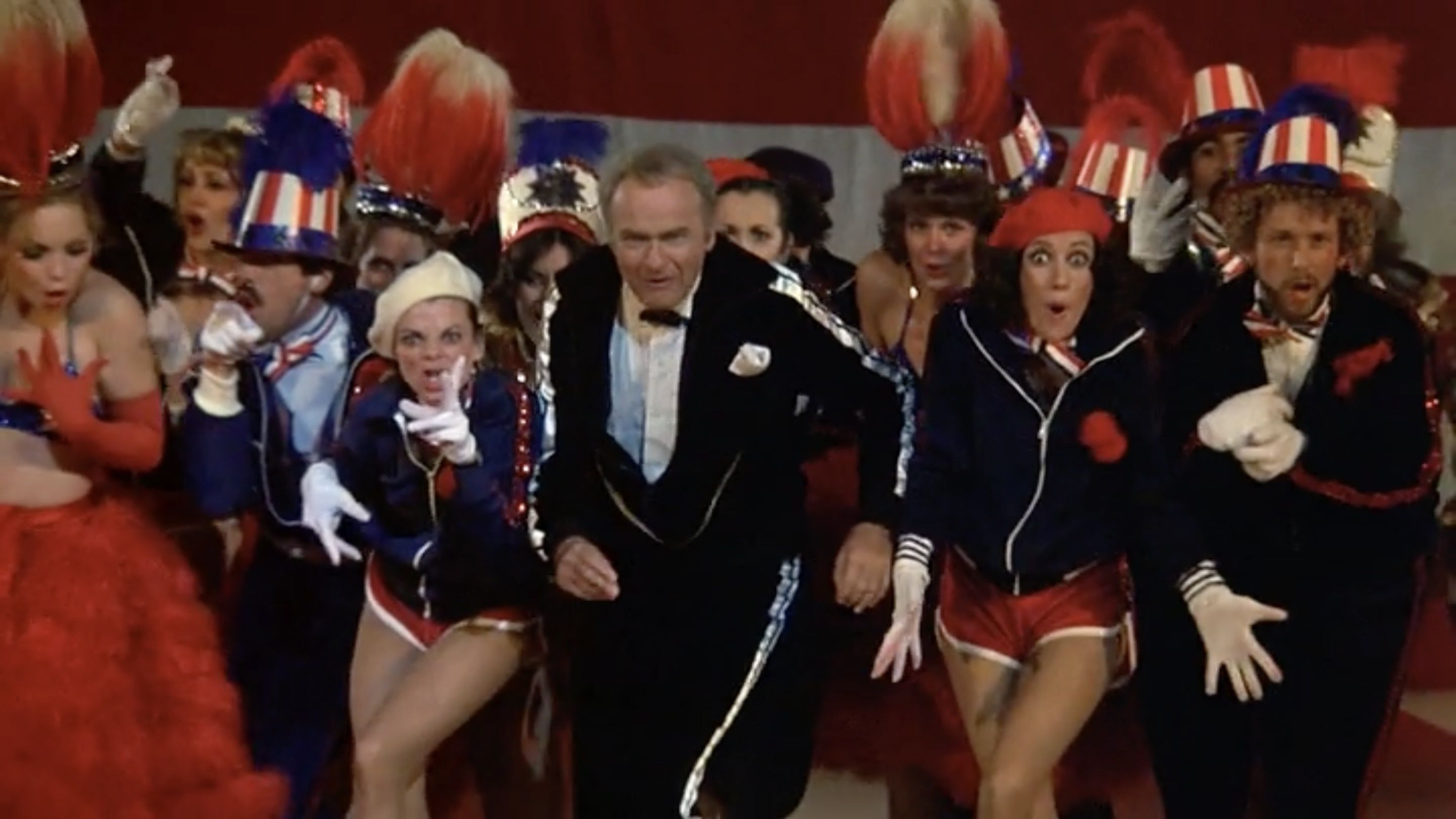 Throughout the film, Korman goes harder than necessary, including the opening telethon number.