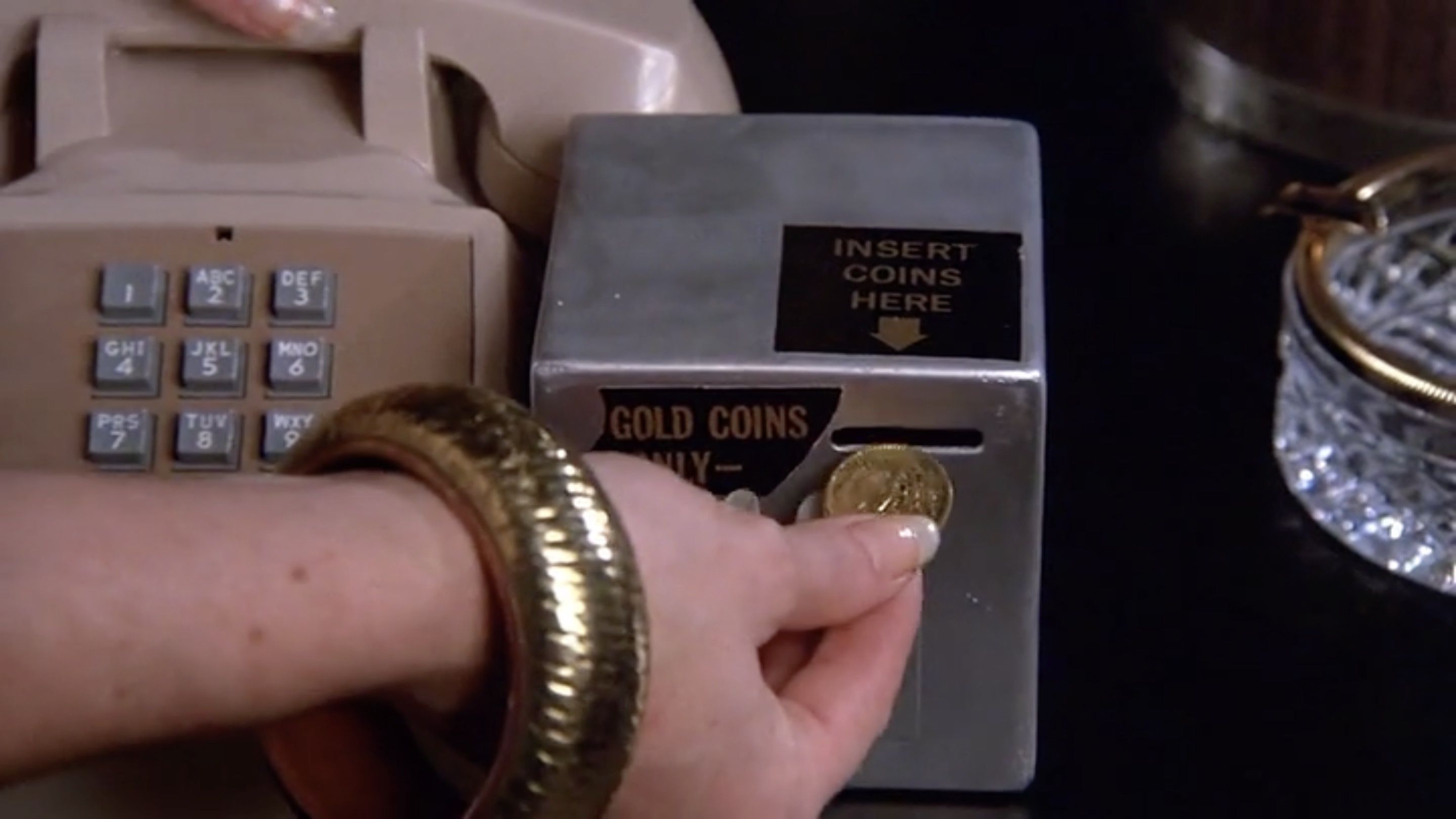 Gold coin-operated phone in the Western White House. Everybody gotta pay.