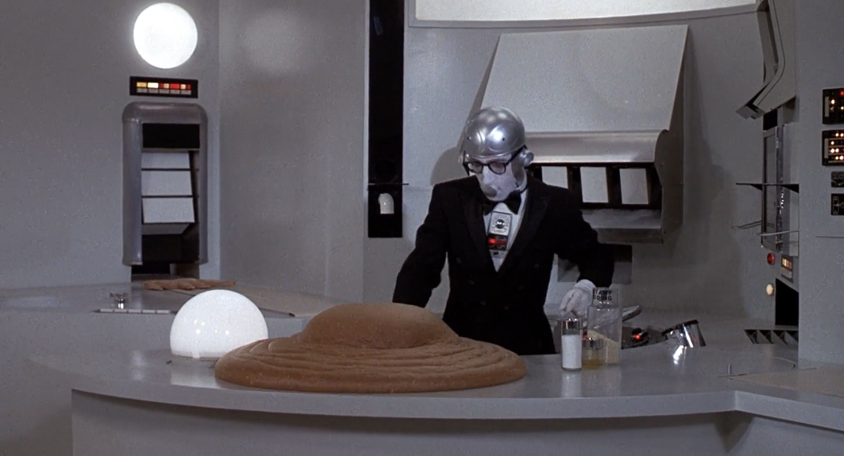 One part that did make me chuckle was Miles as a robot fighting the ever-expanding instant pudding. The “trying to handle a chaotic situation while pretending everything is copacetic” gag always works for me.