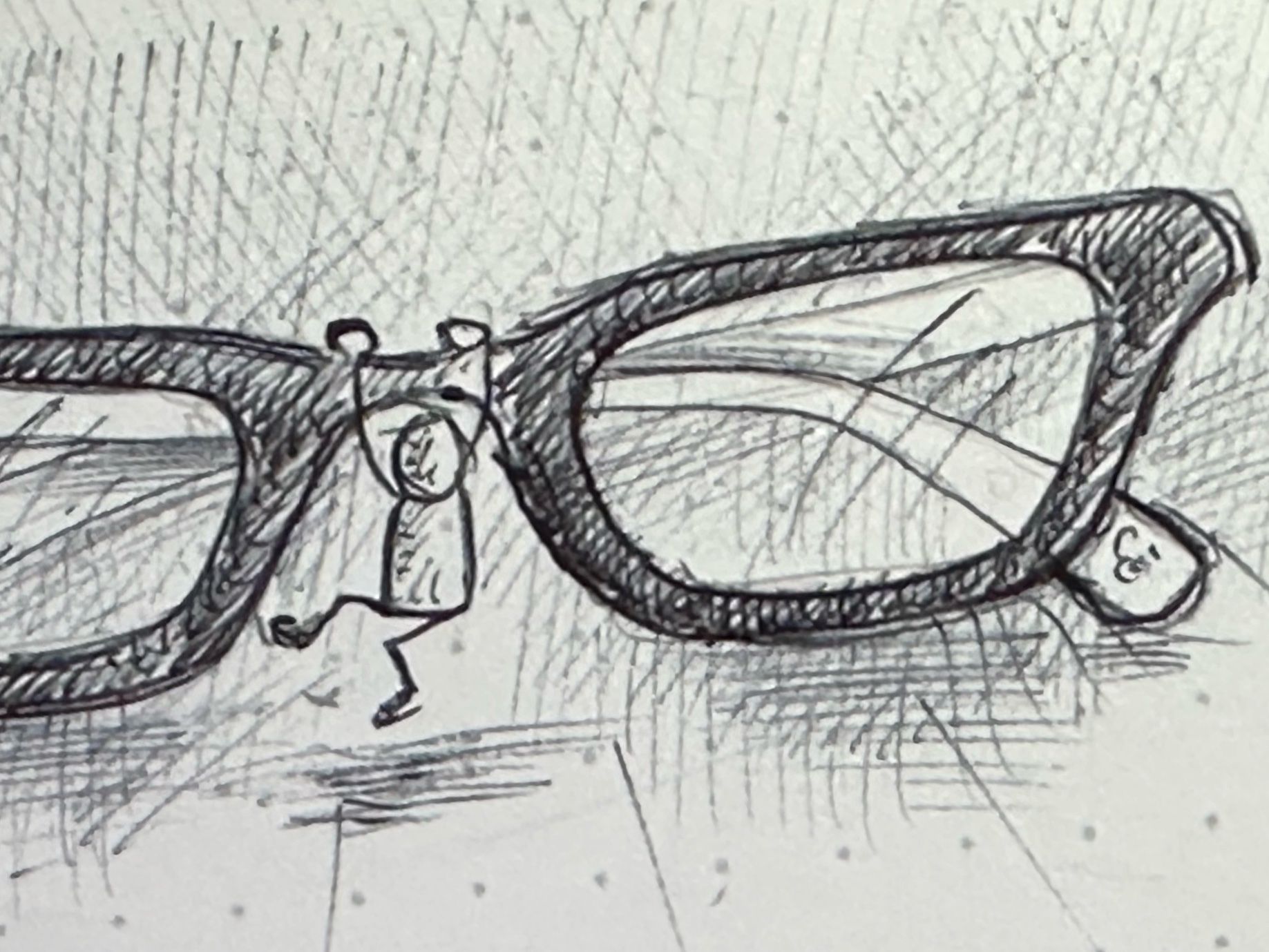 A sketch of a pair of eyeglasses with a tiny figure that appears to be climbing or hanging on the glasses.