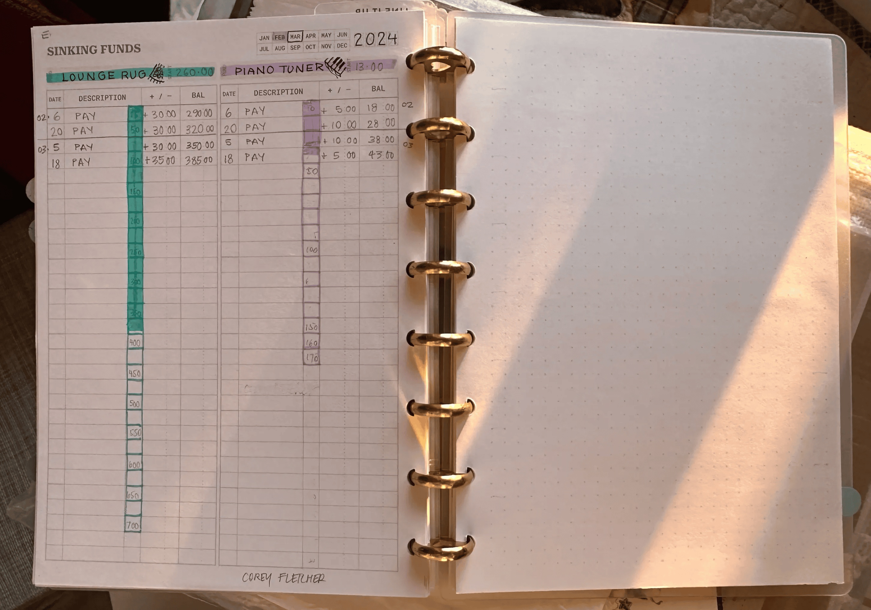 An open discbound A5 notebook with two multi-columned, vertical sections on the left hand page. There’s a vertical row of boxes, with each box representing an amount of money. As that amount is saved, a box is coloured in. It’s a good visual for seeing progress toward a savings goal.