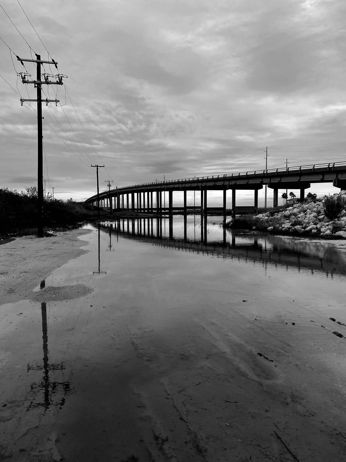 reflections of a bridge and pole in aransas texas