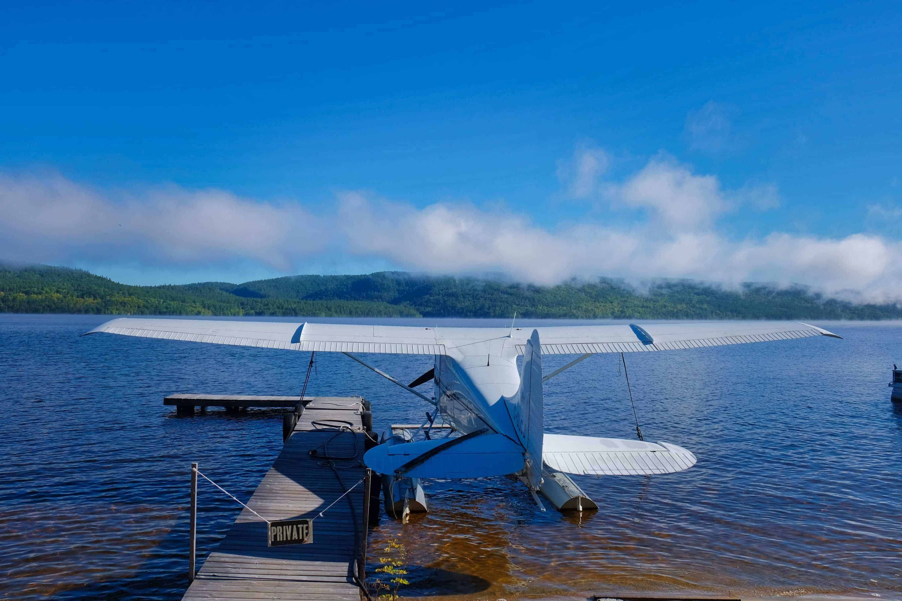 Amphibious airplane docked on lakeshore in Canada