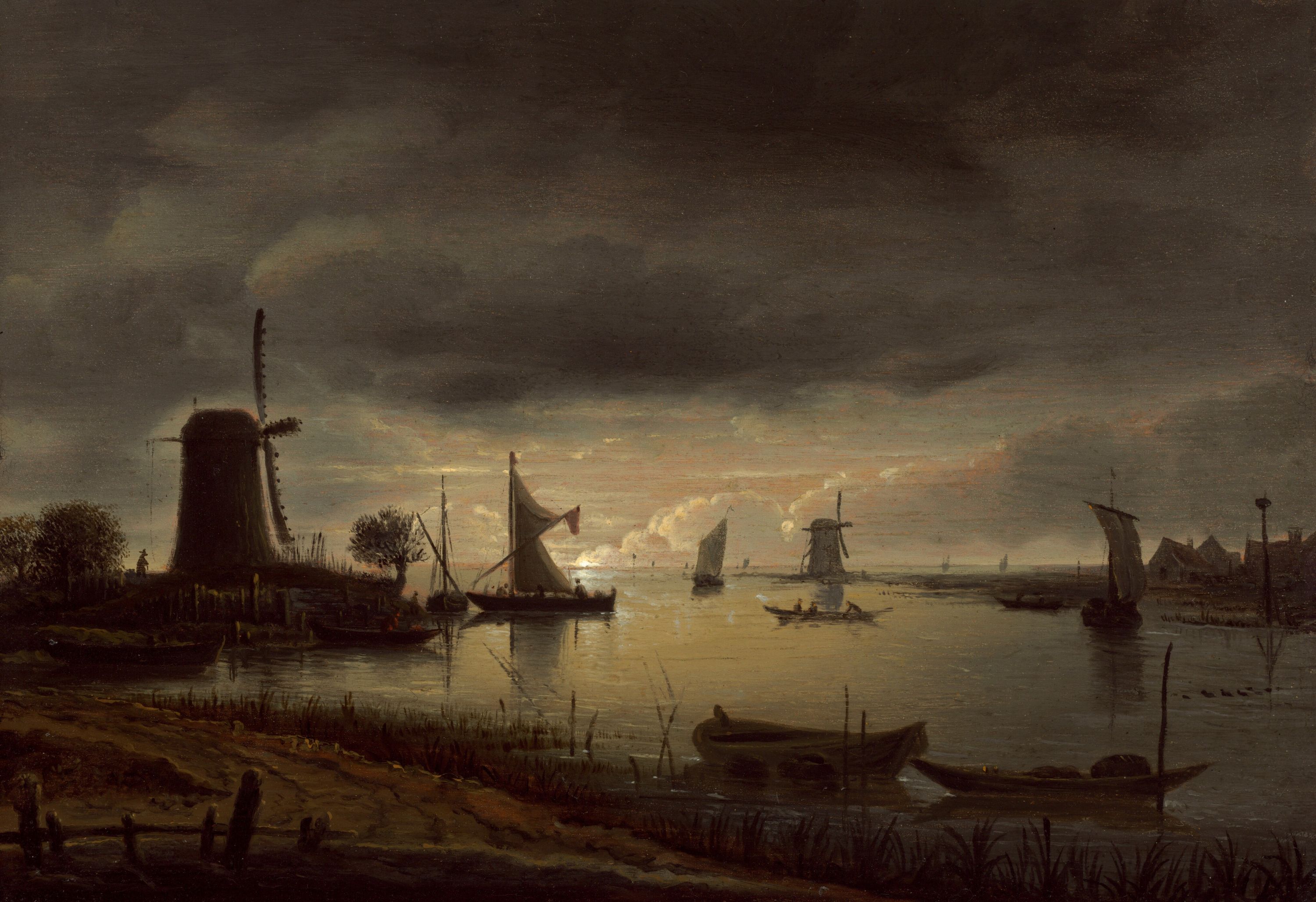 A dimly lit scene with a windmill and boats