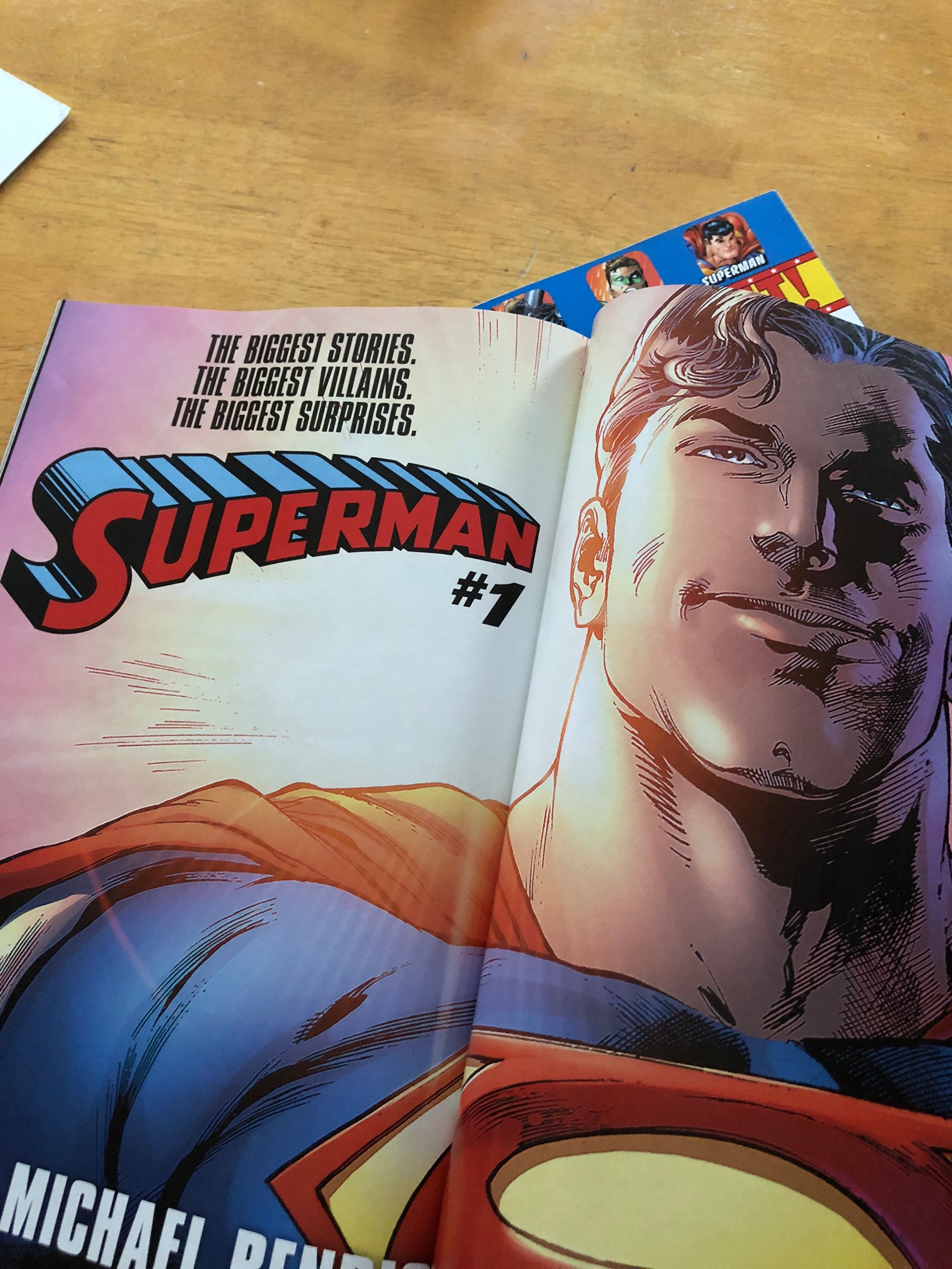 an interior ad for the new Bendis written Superman #1. Shows Superman from the chest up smiling. Text reads: THE BIGGEST STORIES. THE BIGGEST VILLAINS. THE BIGGEST SURPRISES. Superman #1