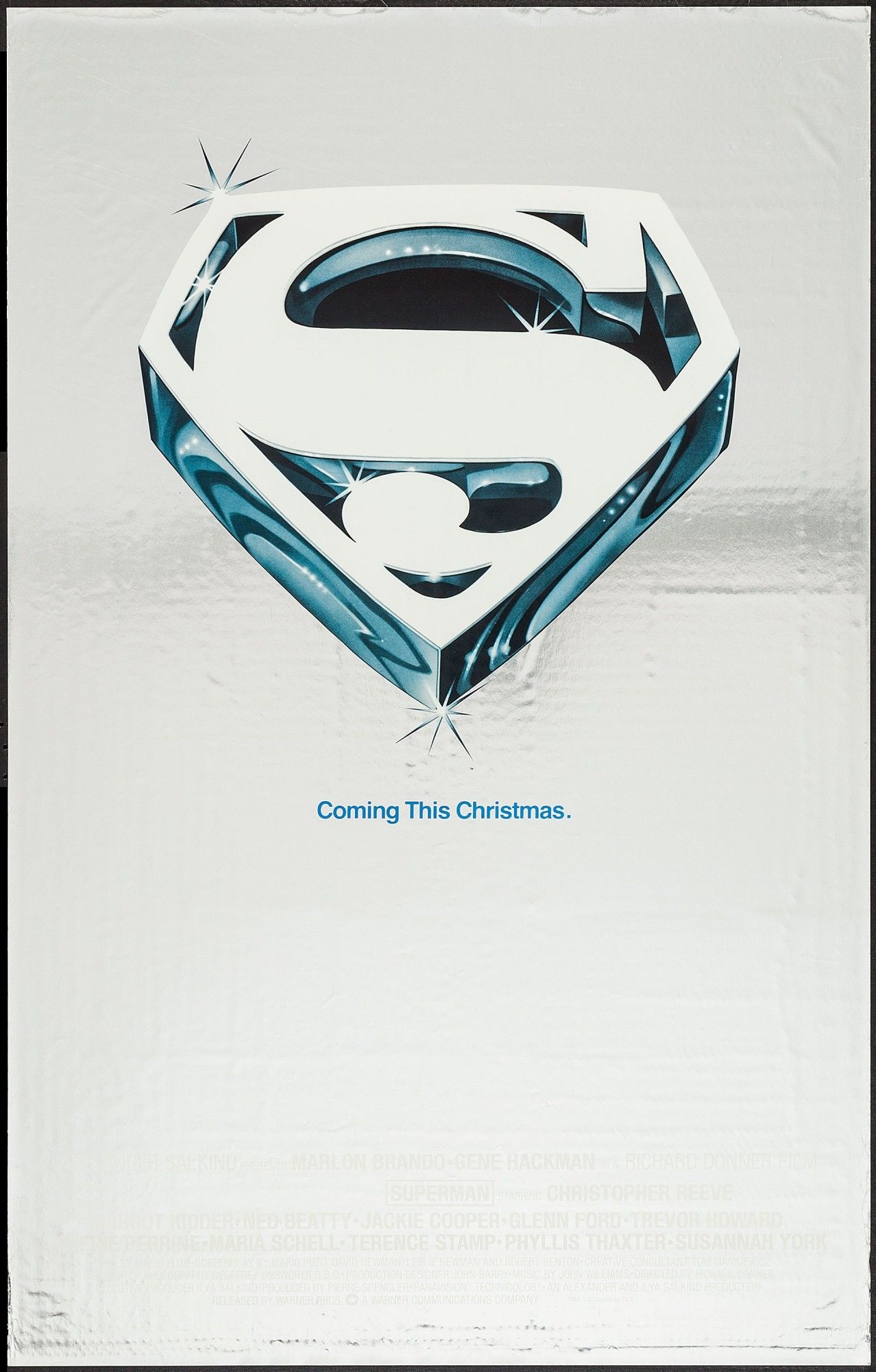 Mylar foil poster with the Superman S shield. Text reads Coming this Christmas.