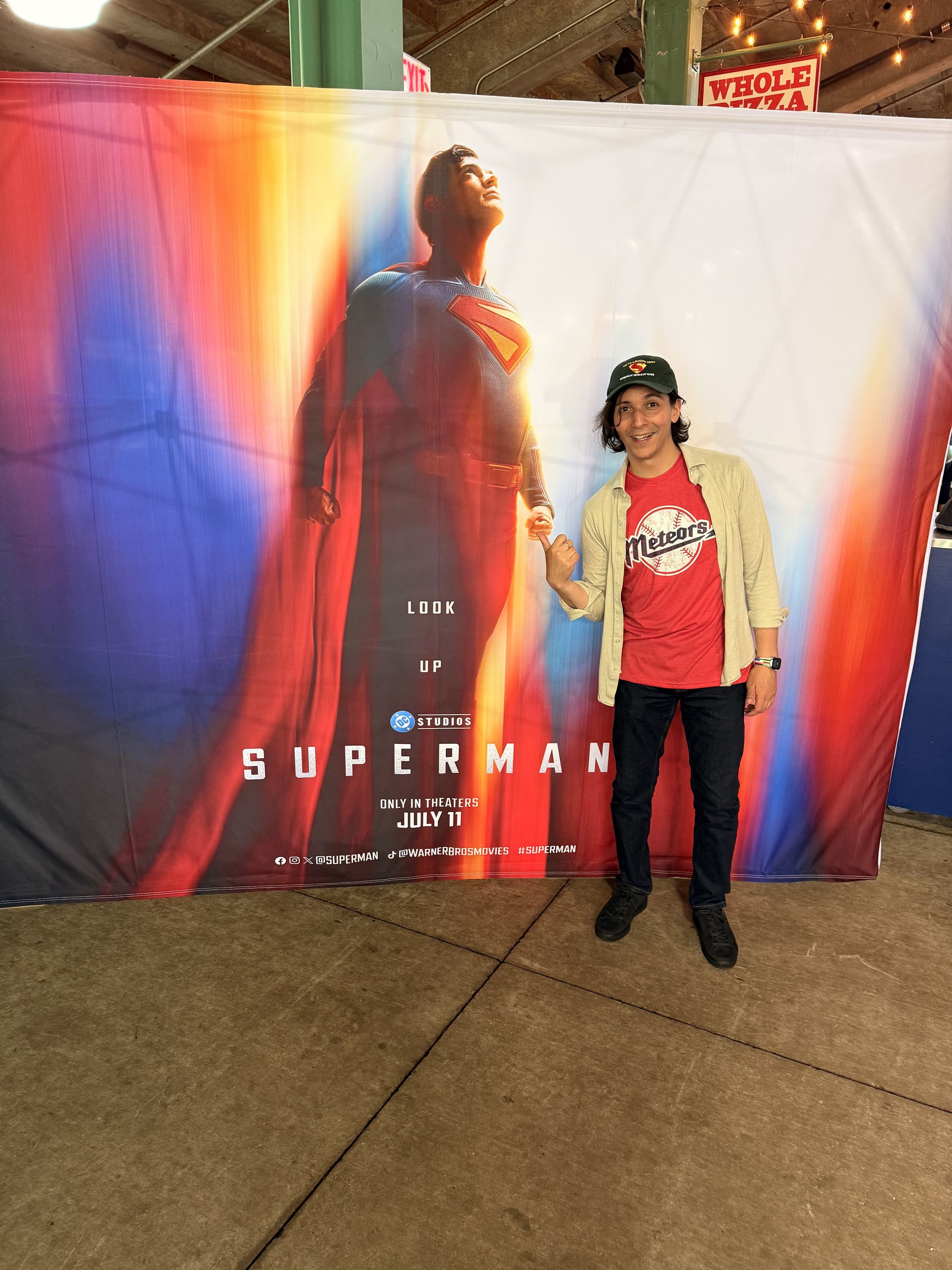 Me standing in front of a Superman banner.