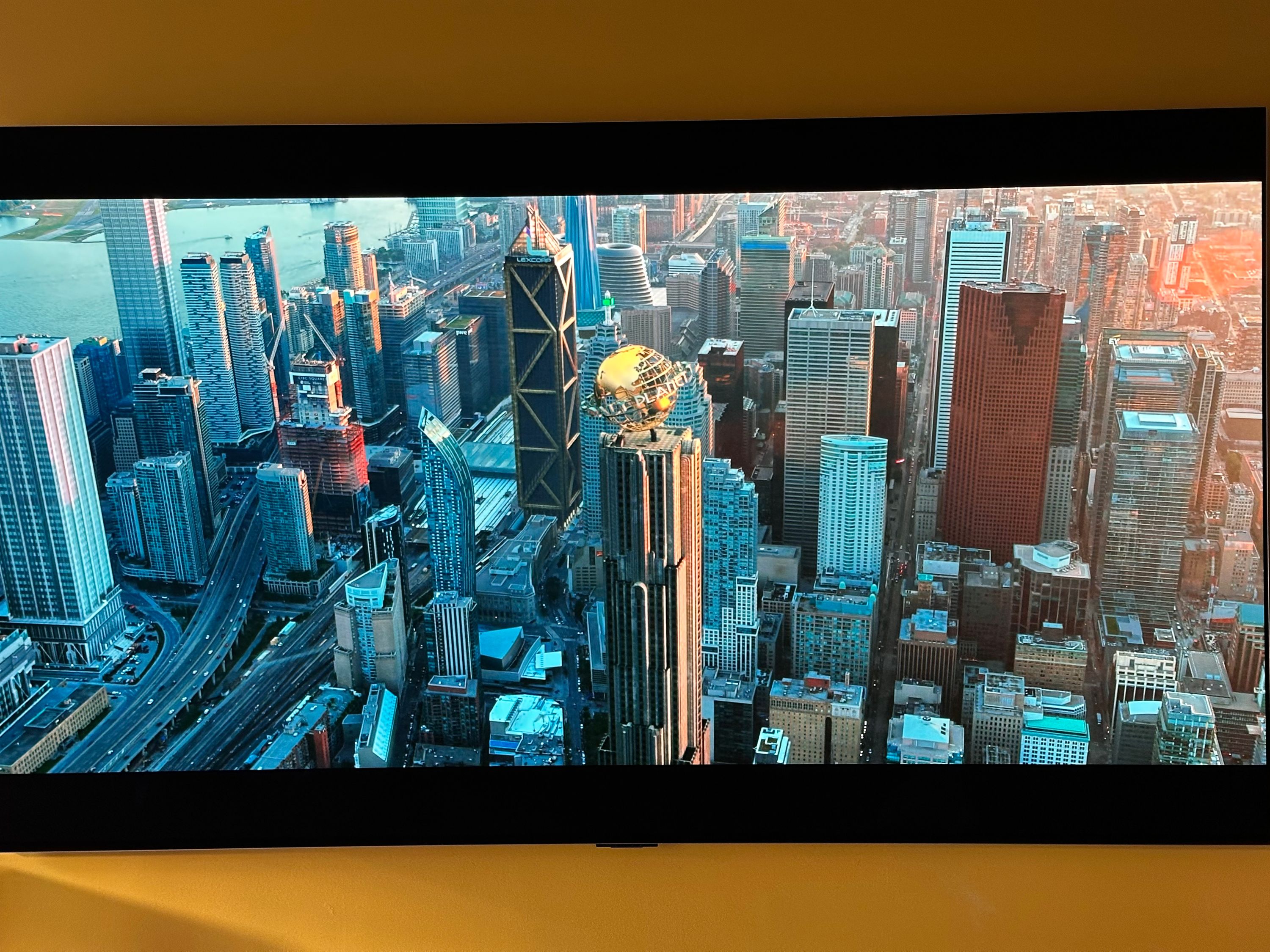 Picture of a television showing the city of Metropolis skyline from the Titans television show on HBO Max. The Daily Planet and LexCorp buildings are clearly shown in the middle.