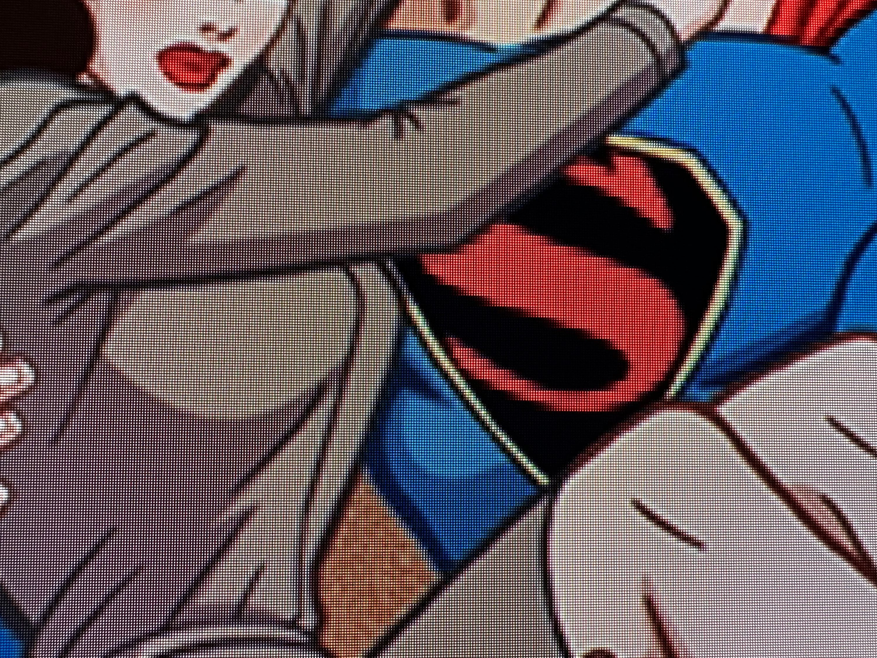 A close up of Superman’s chest showing pixellation on the S logo