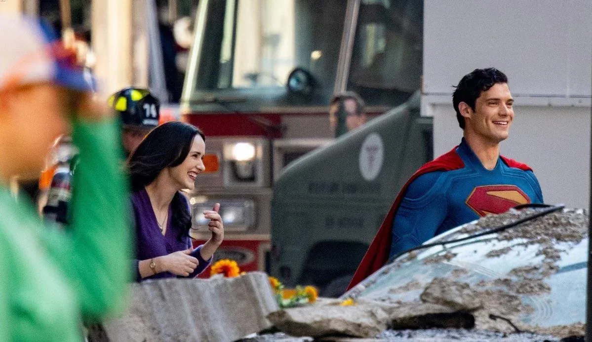 David Corenswet and Rachel Brosnahan in costume as Superman and Lois with big smiles
