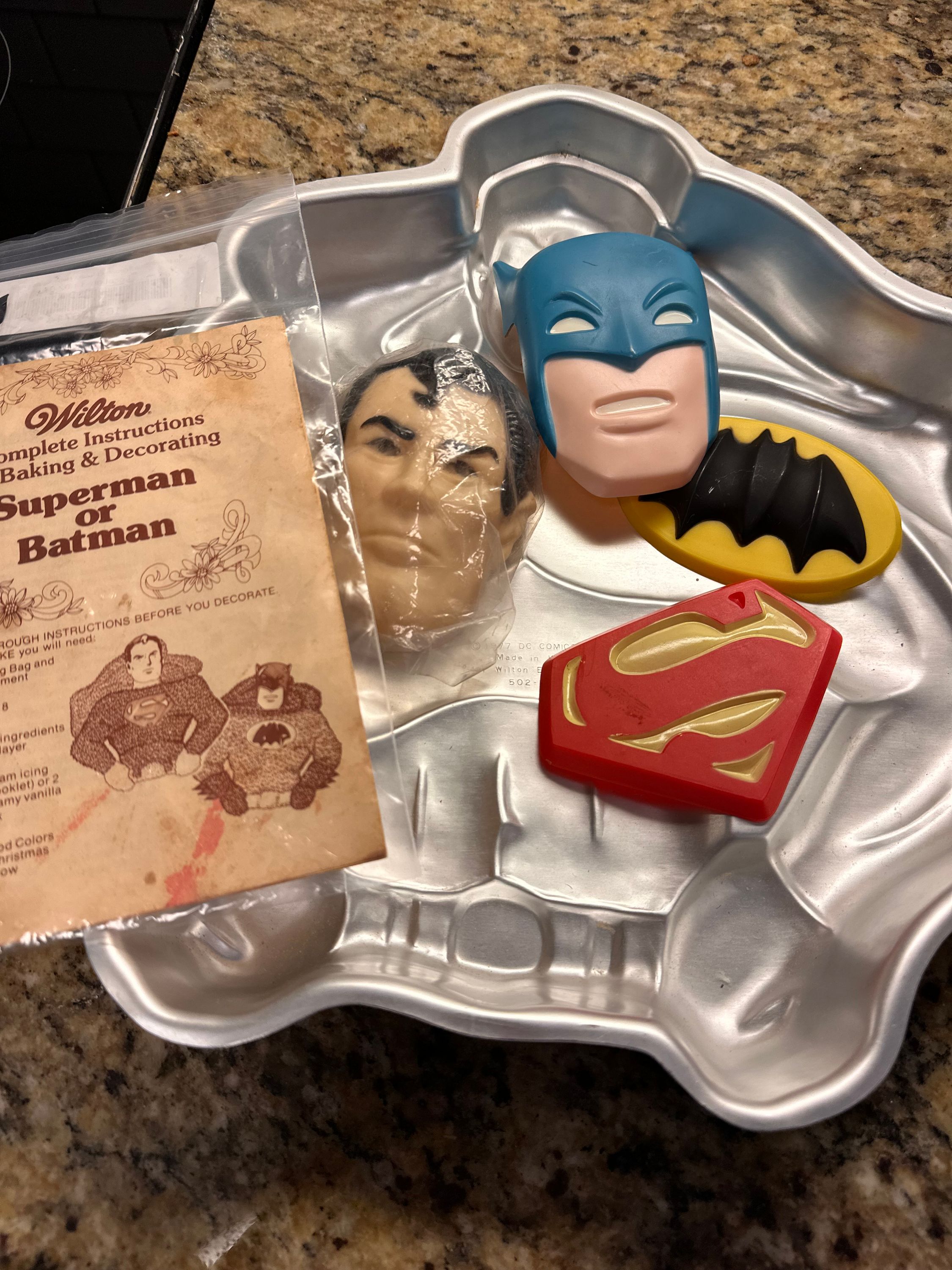 Superman or Batman cake pan with accessories and instructions