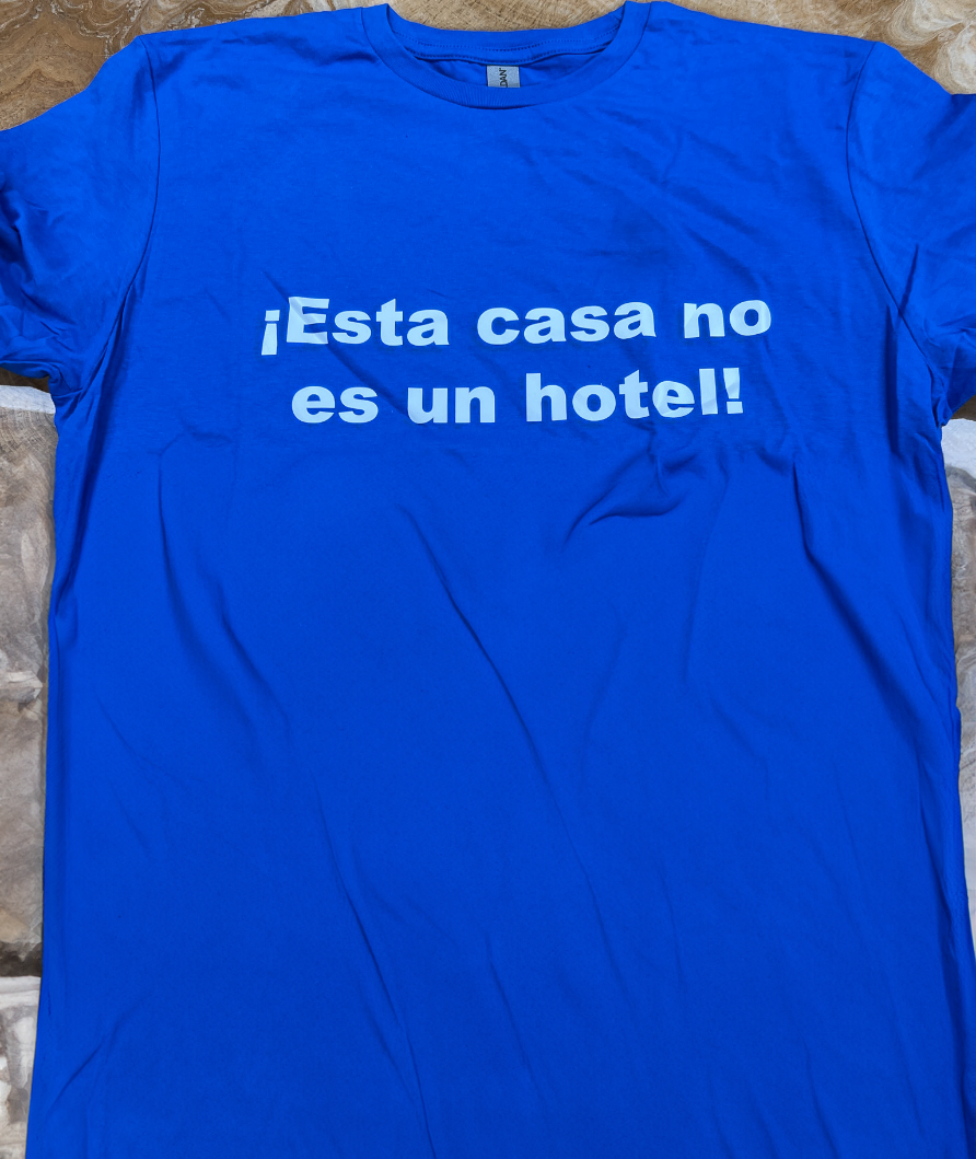 A blue shirt with white text on it Description automatically generated