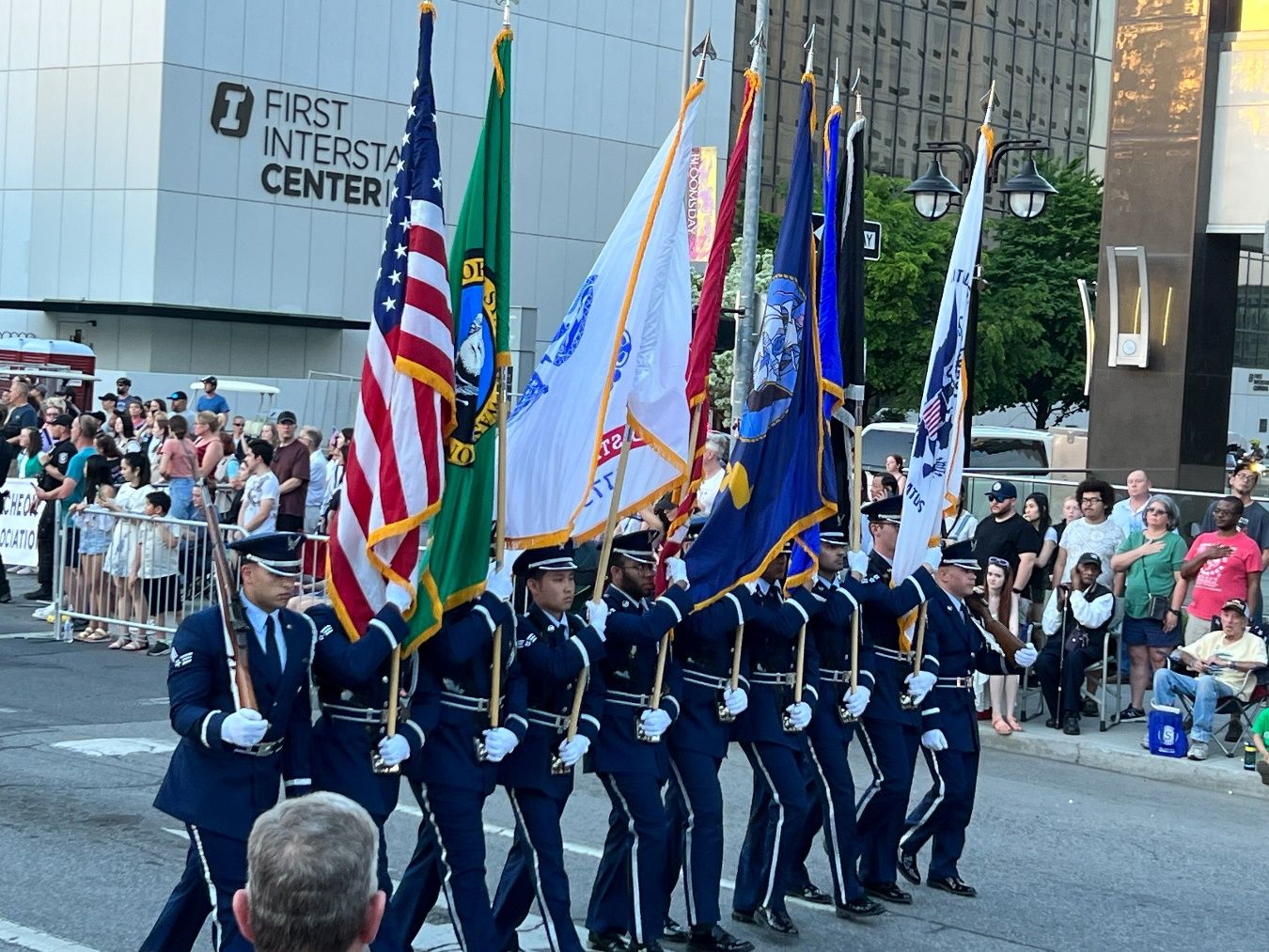 A group of people in uniform marching in a parade Description automatically generated