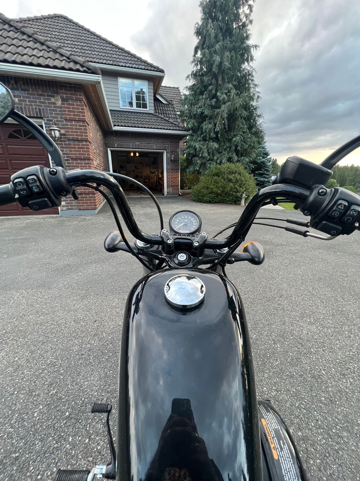 A motorcycle parked in a driveway Description automatically generated