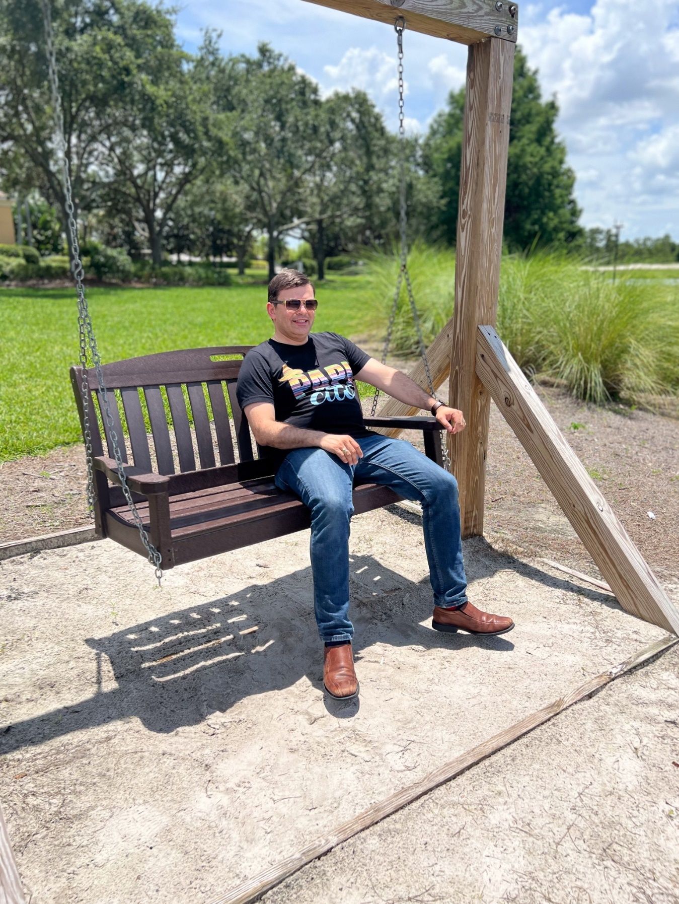 A person sitting on a swing Description automatically generated