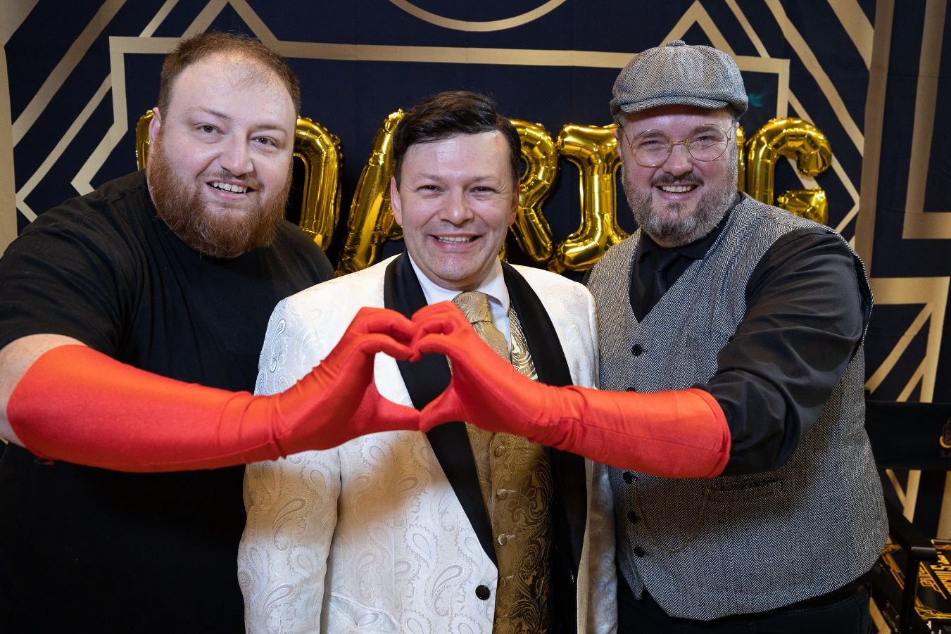 A group of men making a heart with their hands Description automatically generated