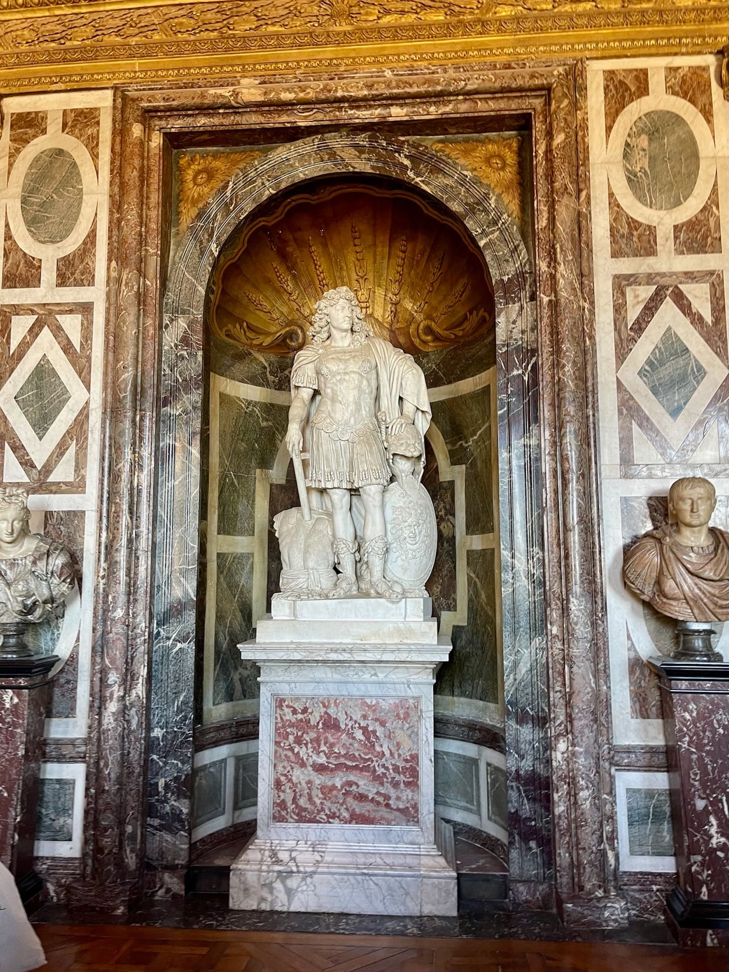 A statue of a person in a room with marble walls AI-generated content may be incorrect.