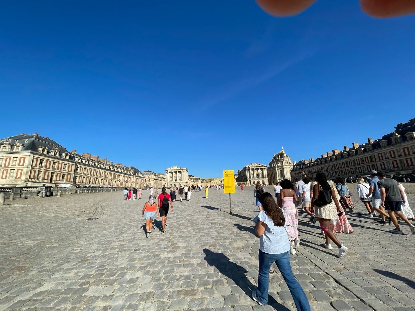 A group of people walking on a cobblestone street AI-generated content may be incorrect.