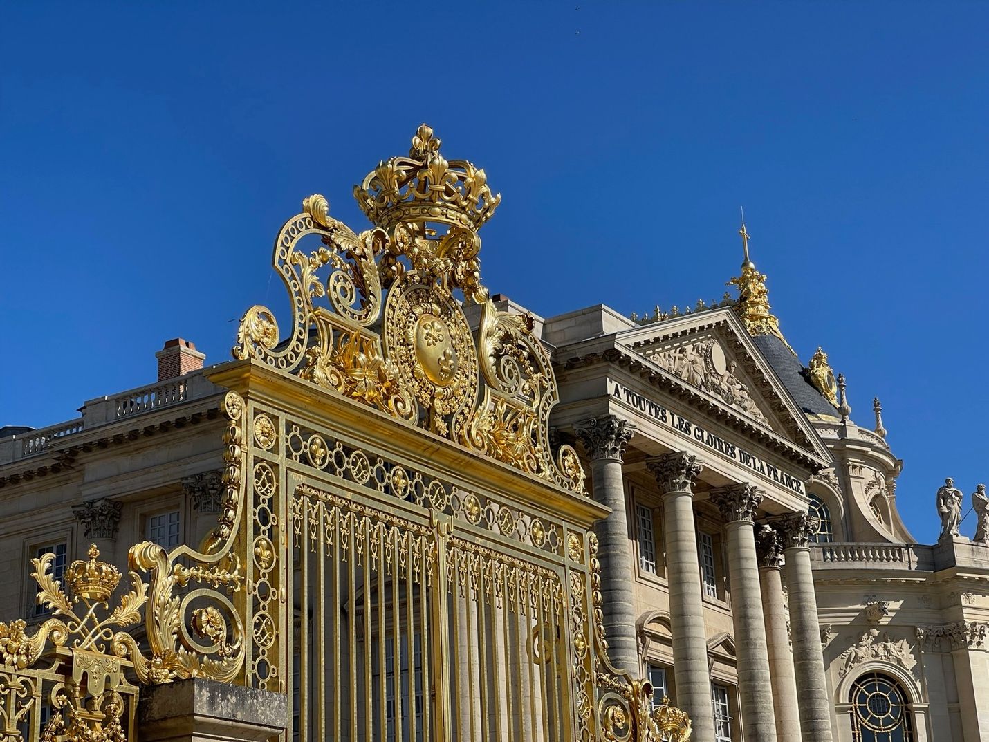 A large ornate gold gated entrance to a building AI-generated content may be incorrect.