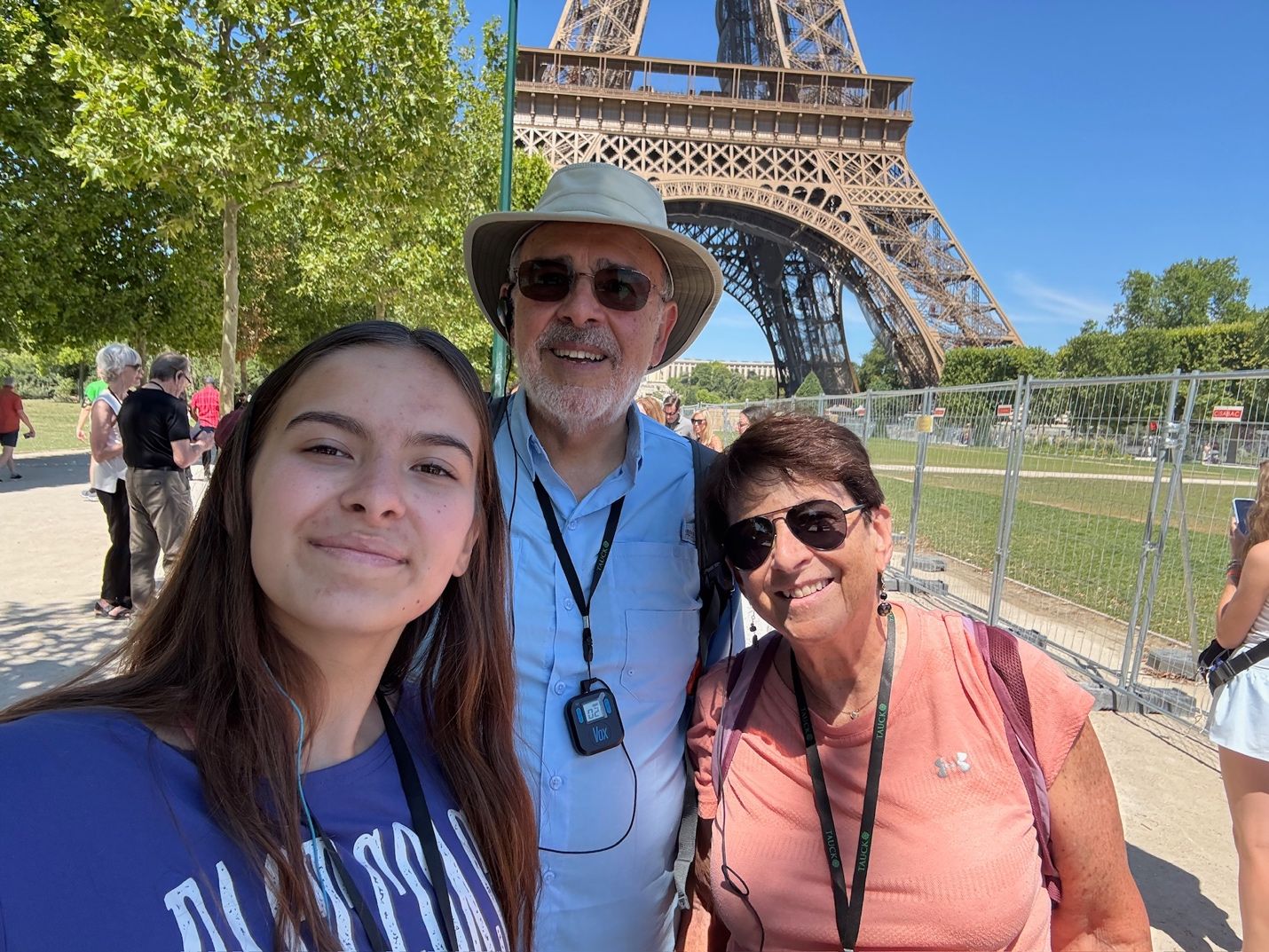 A group of people posing for a photo in front of a metal tower AI-generated content may be incorrect.