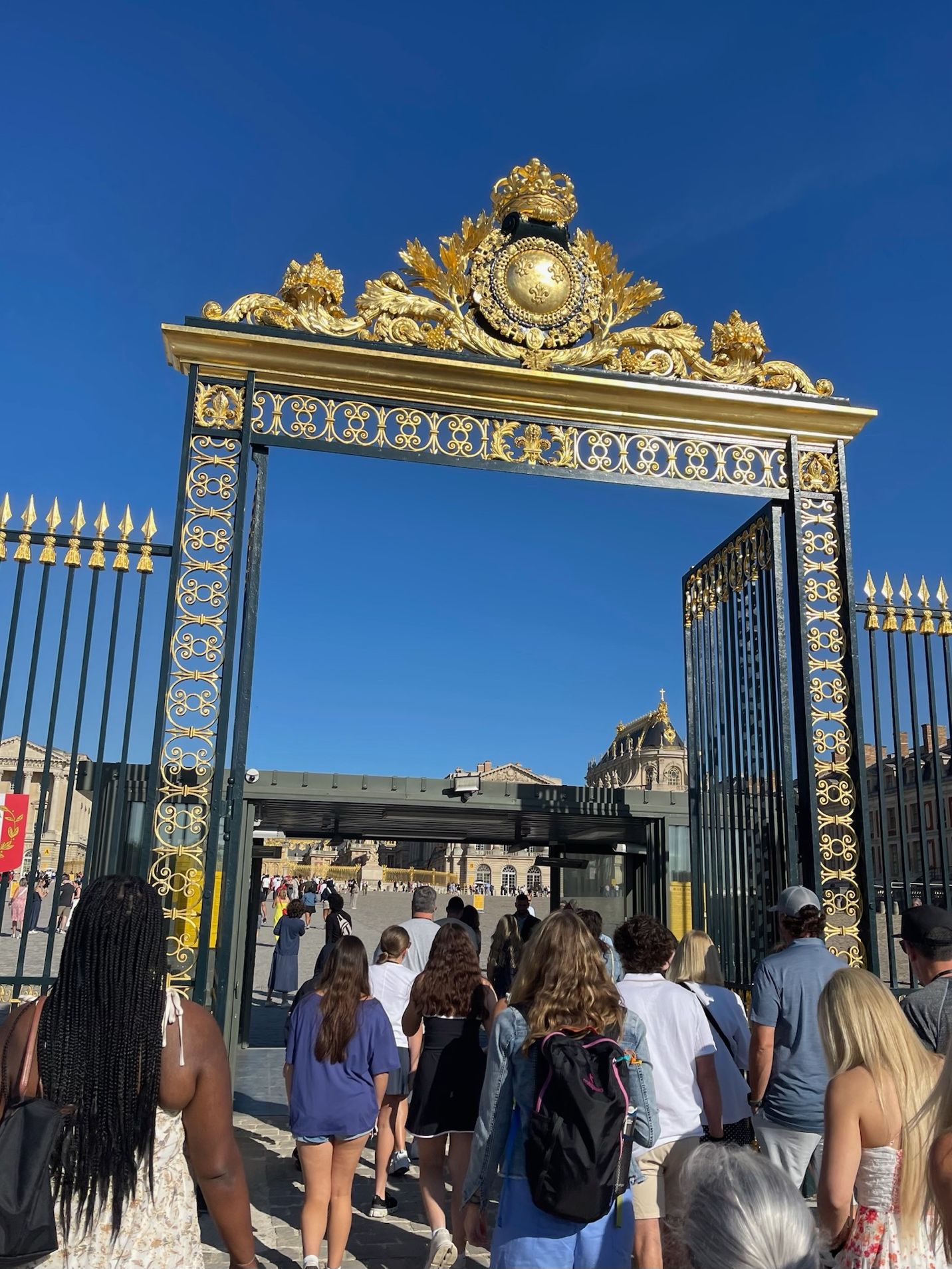 A group of people walking through a gate AI-generated content may be incorrect.