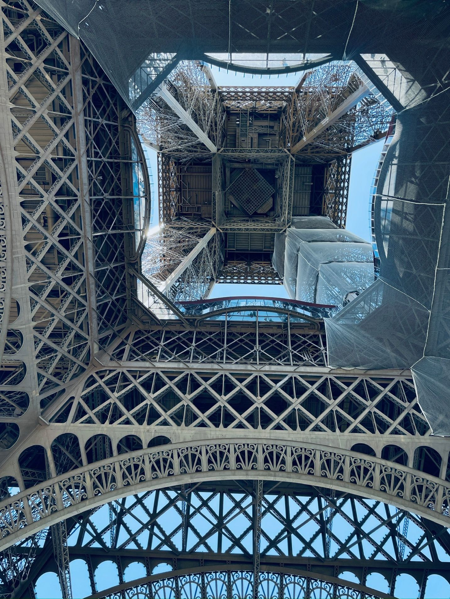 Looking up at the eiffel tower AI-generated content may be incorrect.