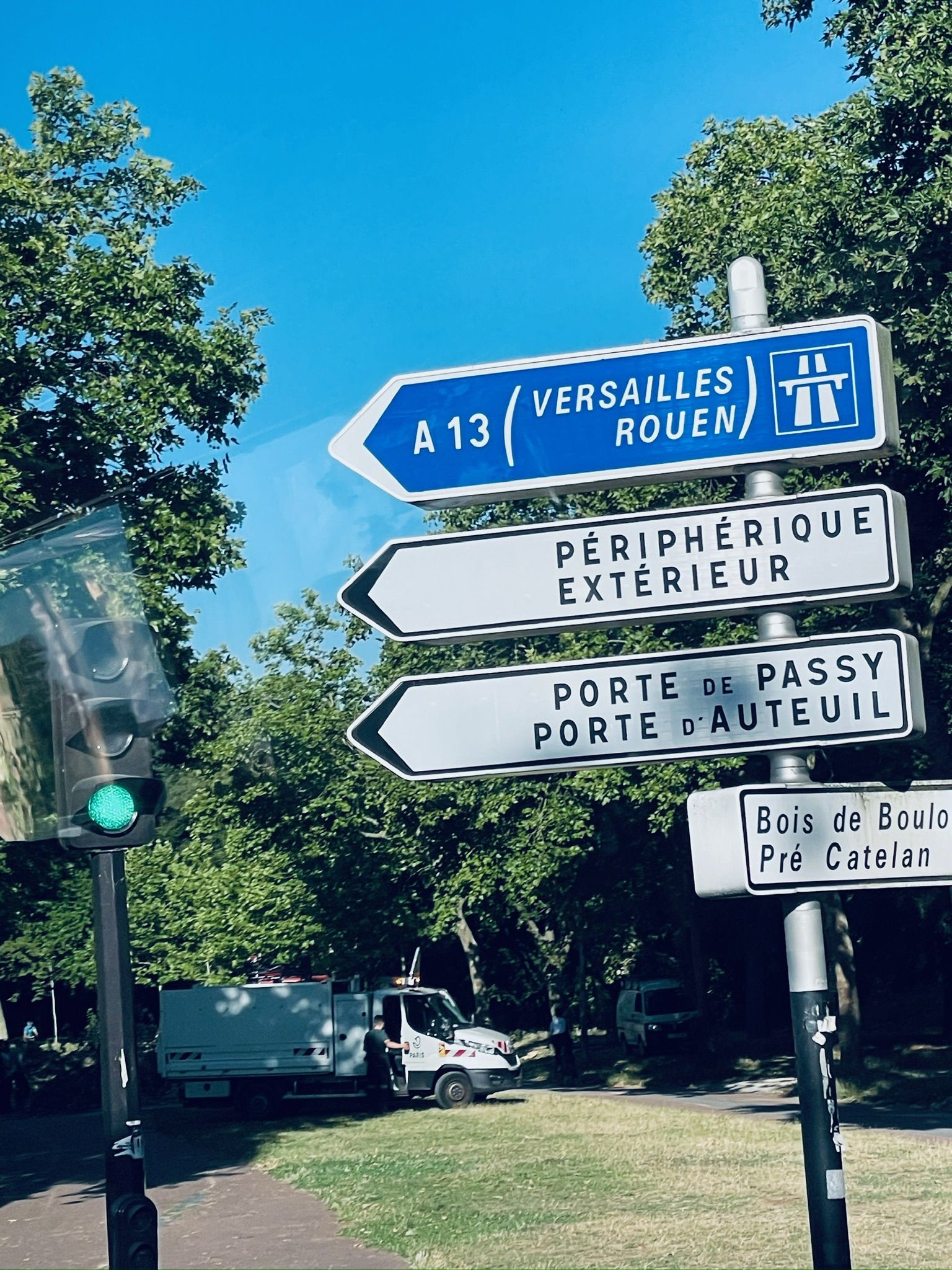 A street sign with street signs and a traffic light AI-generated content may be incorrect.