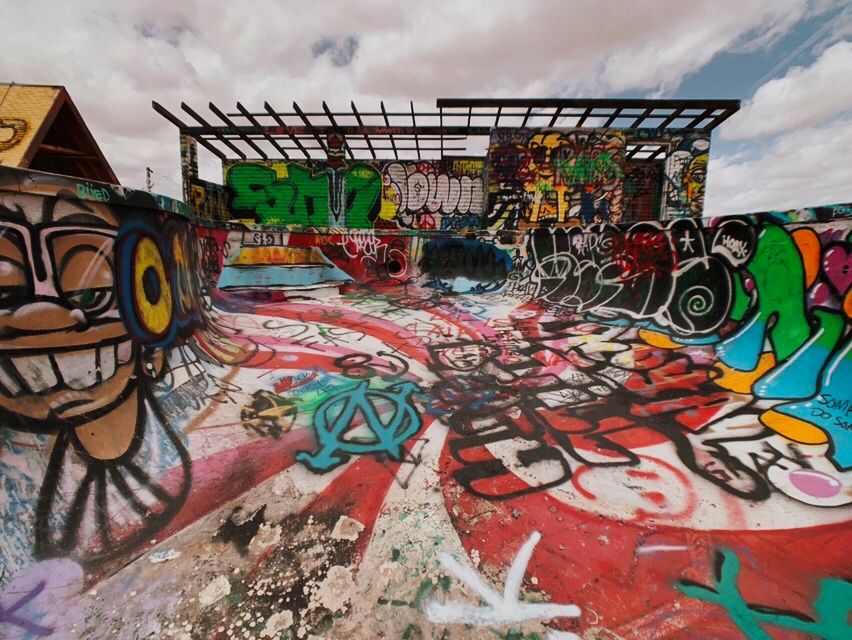 An empty skateable swimming pool covered with Graffiti in AZ