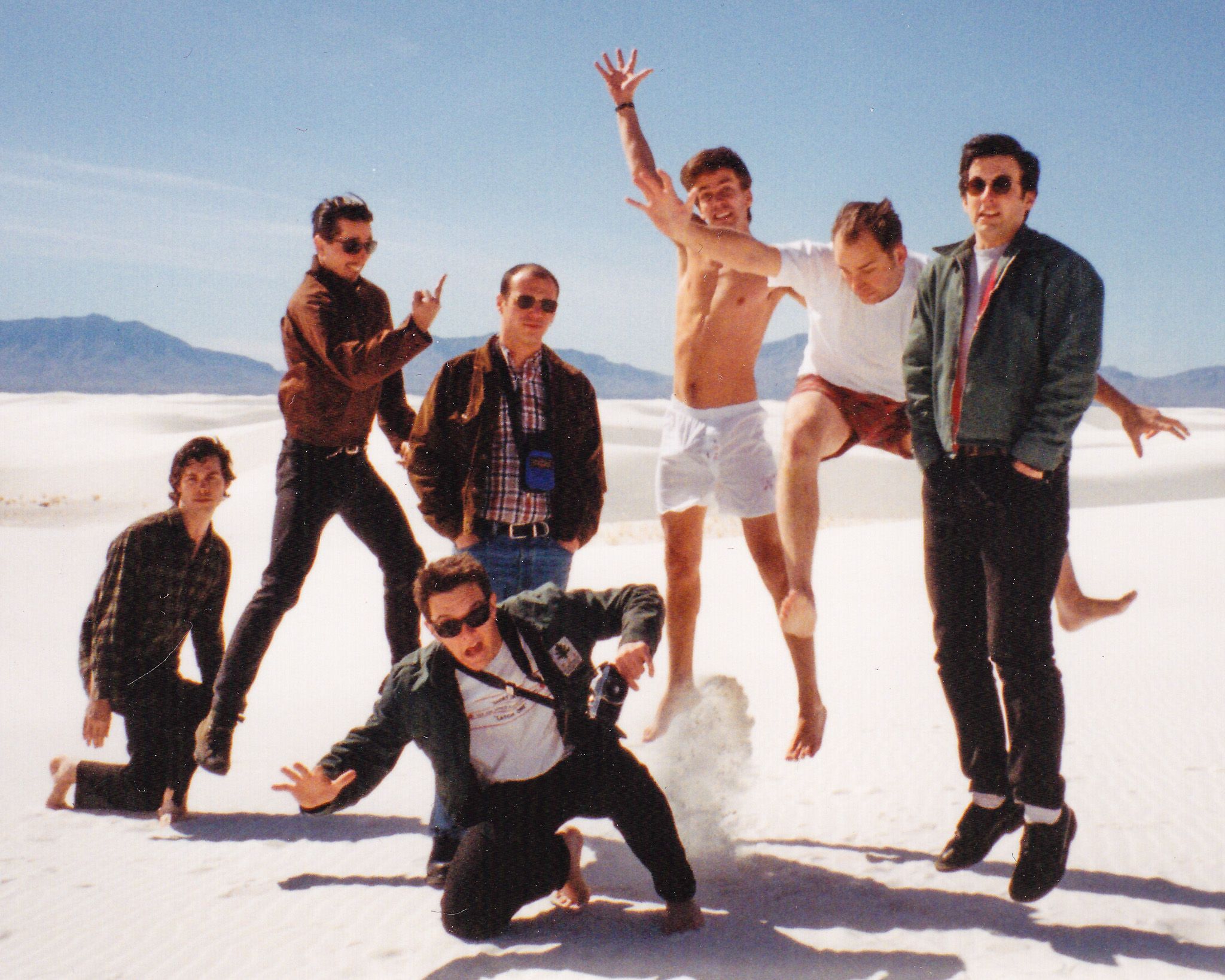 L-R, White Sands, NM, February, 1994: Eli Janney, Bill Barbot, Mike Harbin (falling forward), Me (getting the finger from Bill), Johnny Temple, J. Robbins, Alexis Fleisig. Photo (probably) by Kim Coletta, but it might have been Scott McCloud or Whitney O’Keeffe.