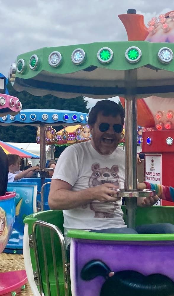 Me, wearing shades and looking unreasonably happy on the teacup ride