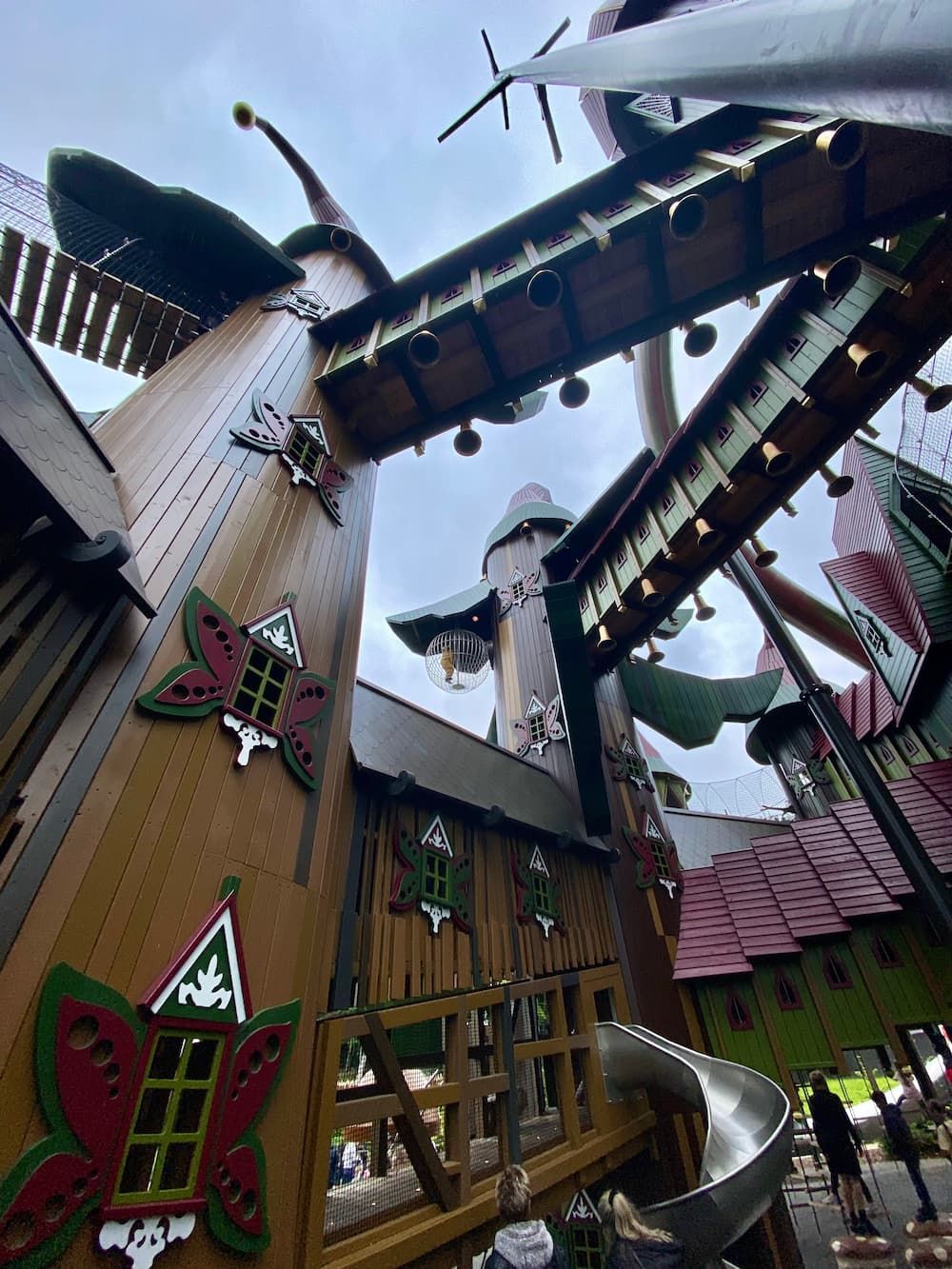 Lilidorei play structure viewed from the ground, a tiny Piglet suspended in the air