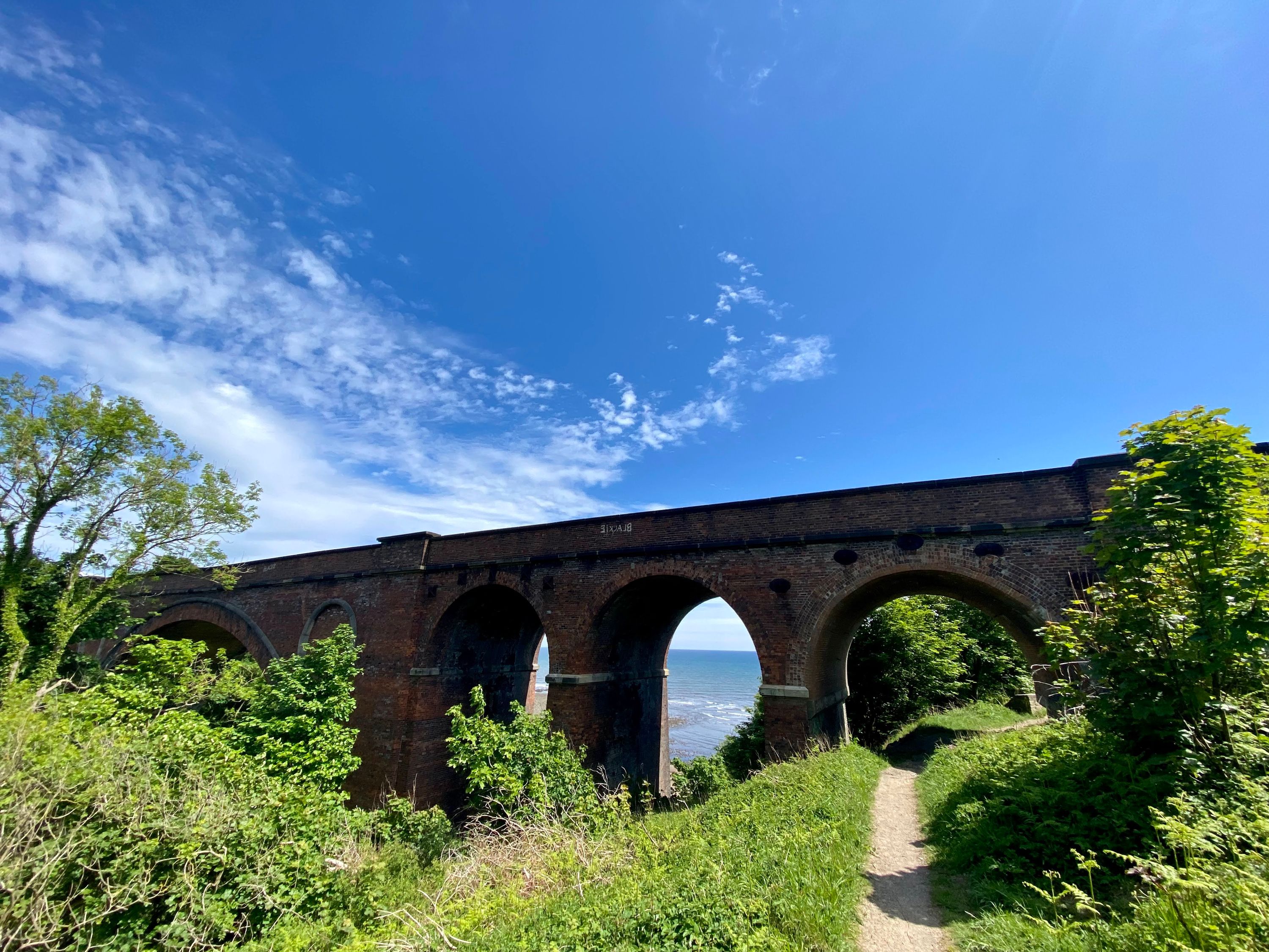 A brick rail bridge on a sunny day