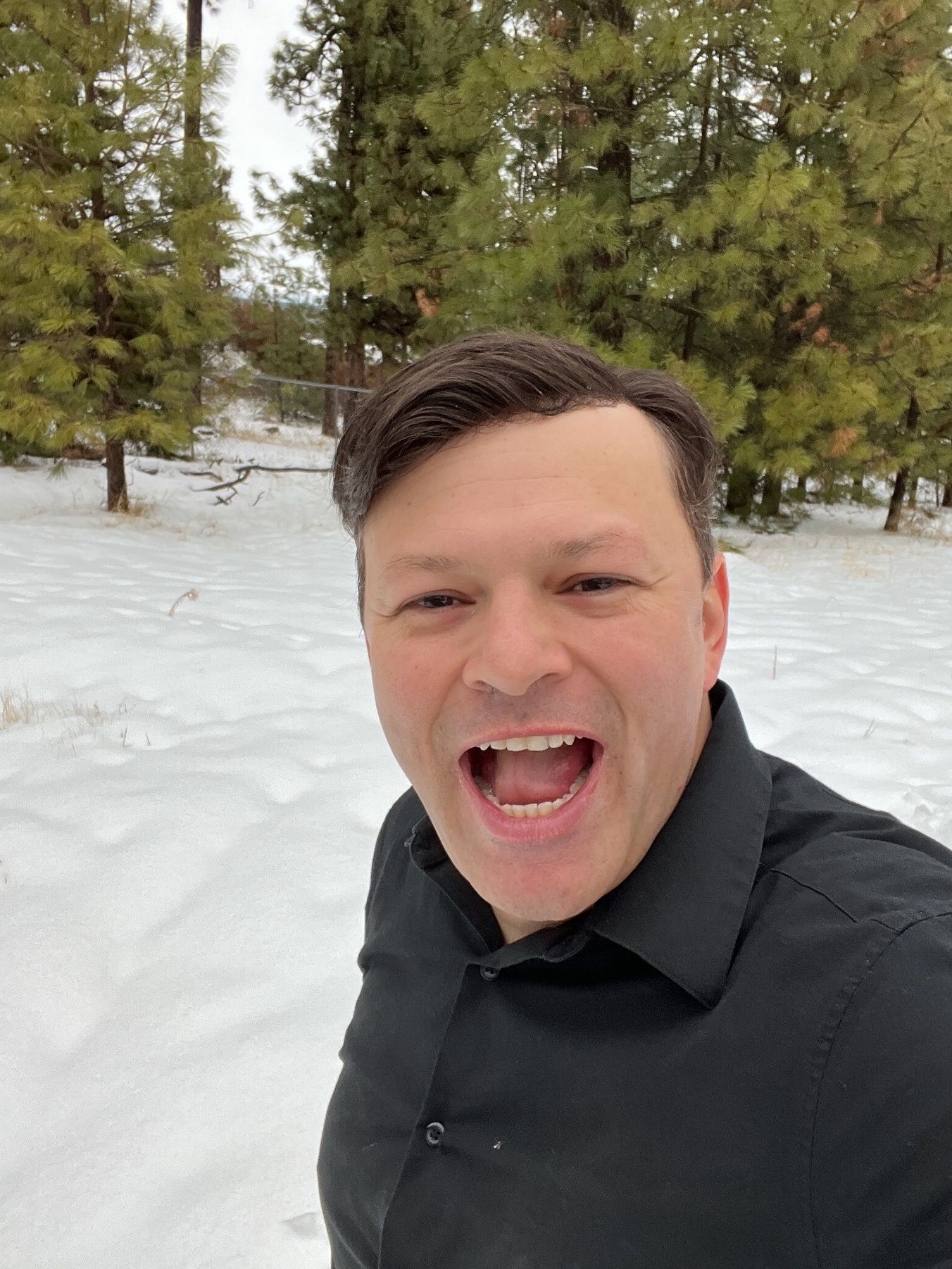 A person taking a selfie in the snow Description automatically generated