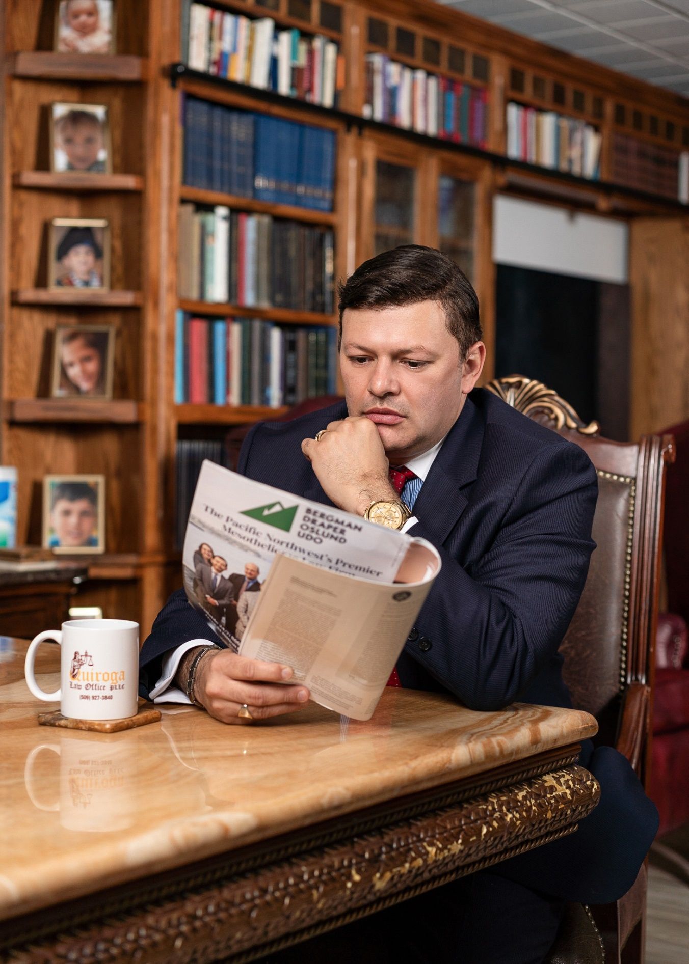 A person sitting at a table reading a newspaper Description automatically generated