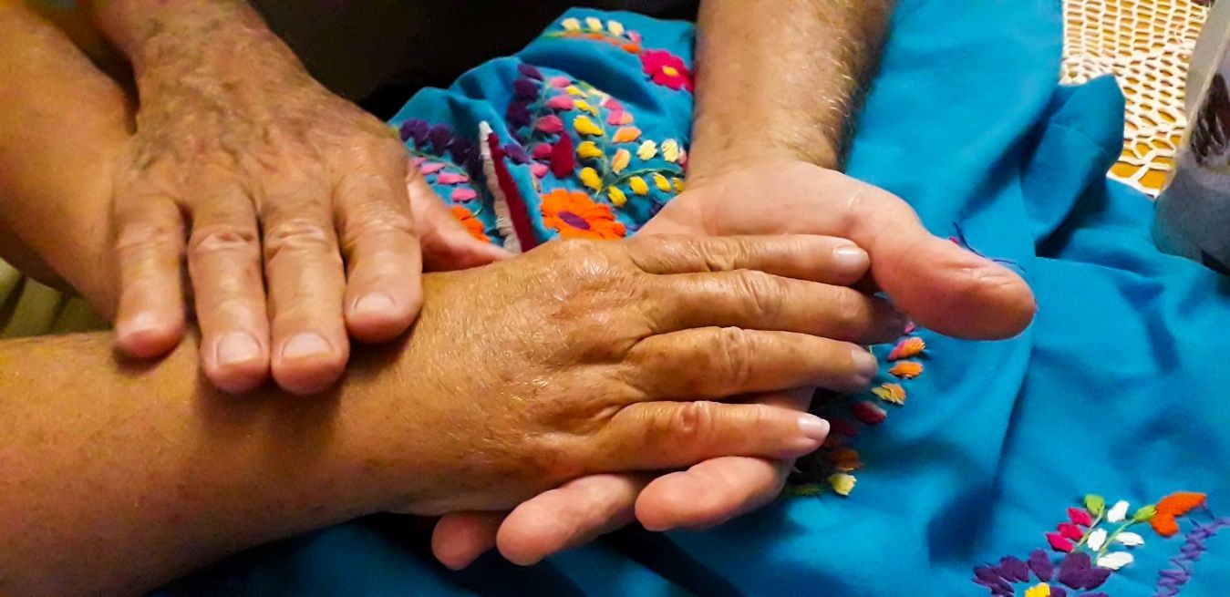 A close up of hands holding each other Description automatically generated