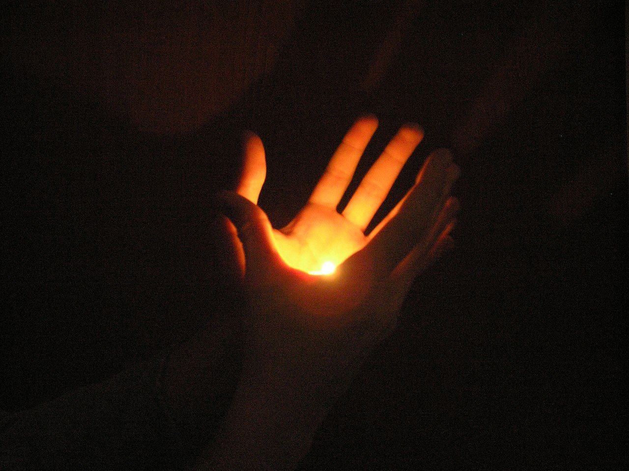 An amateur “flame-in-hand” illusion with a hidden tealight candle.