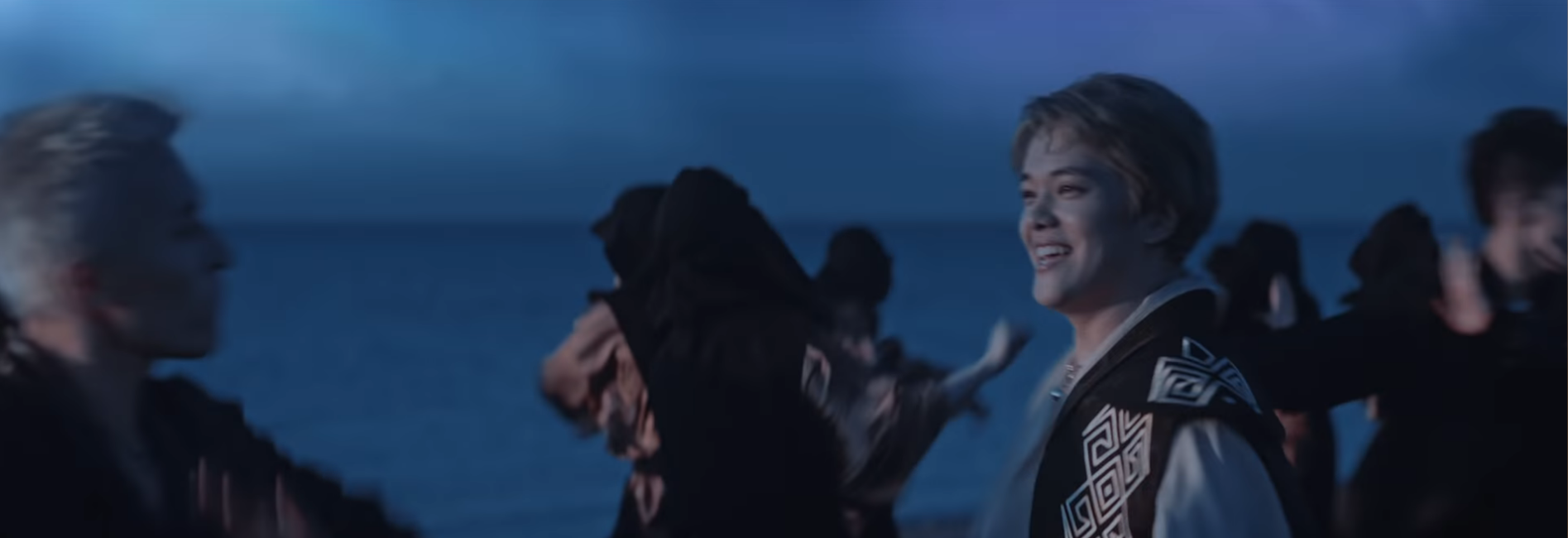 Image of Ninety One and backup dancers at night on the beach, with ZaQ at left, Ace in the center (looking to his left and smiling), and Bala at right