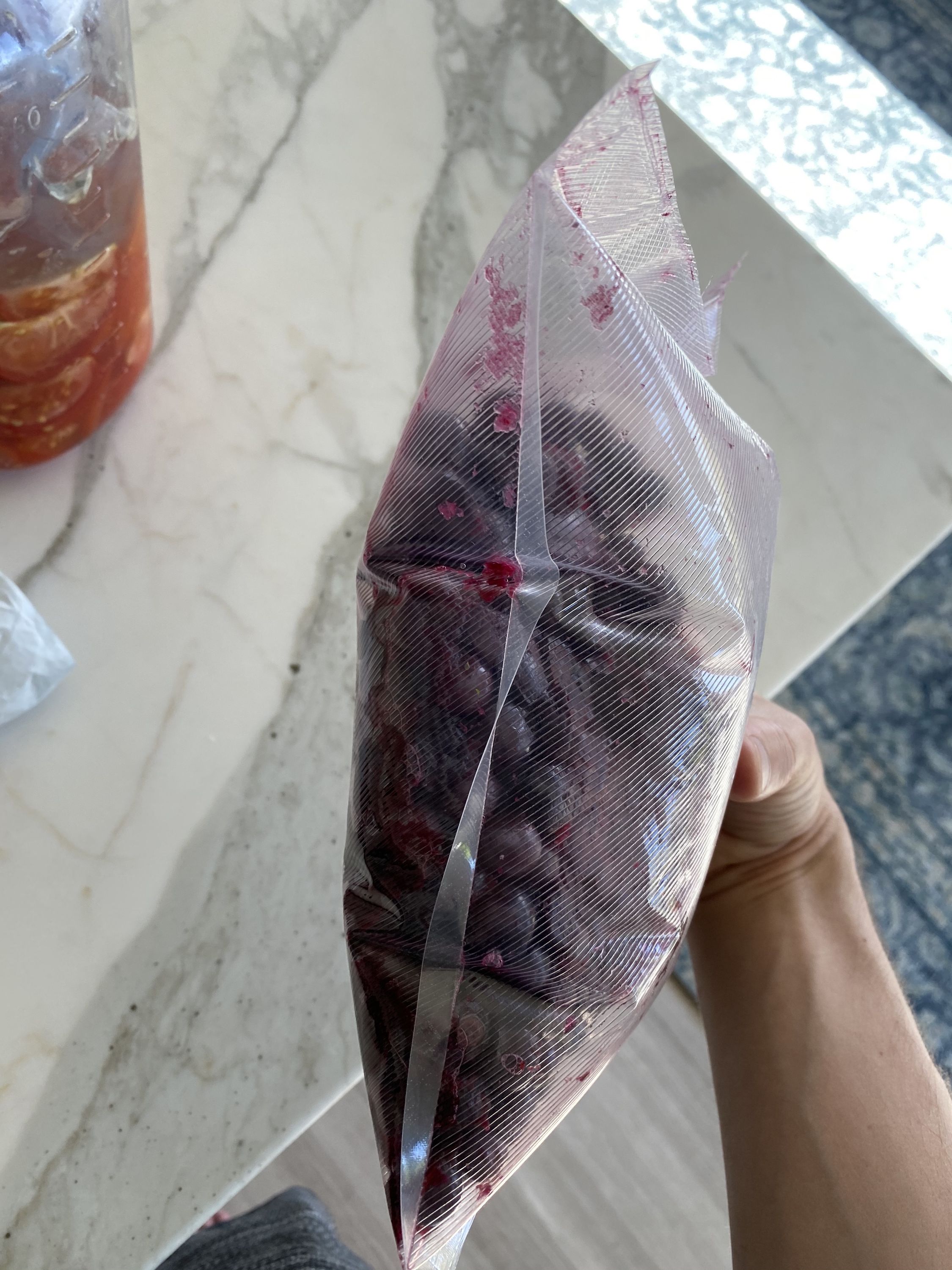 A vacuum-sealed bag of blueberries, puffy with gas
