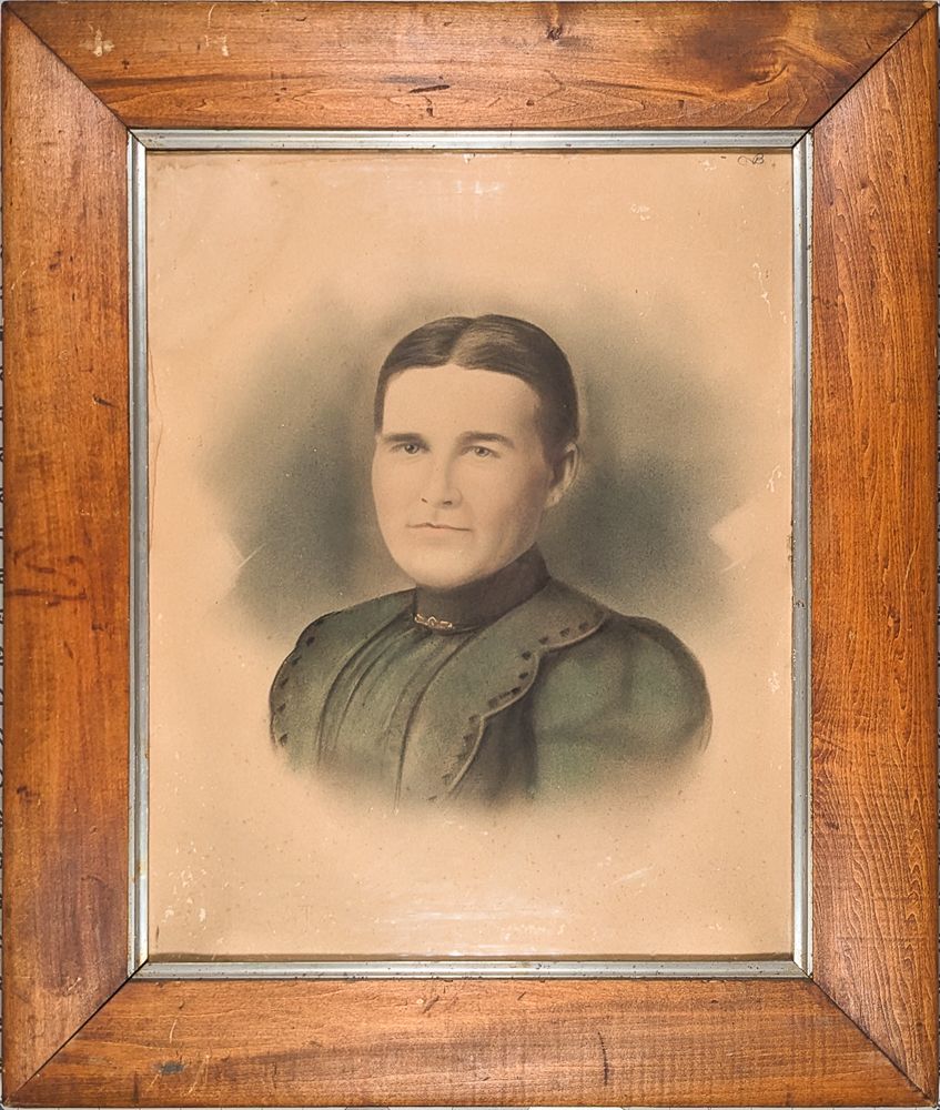 Antique portrait of a woman wearing a green dress in a simple frame