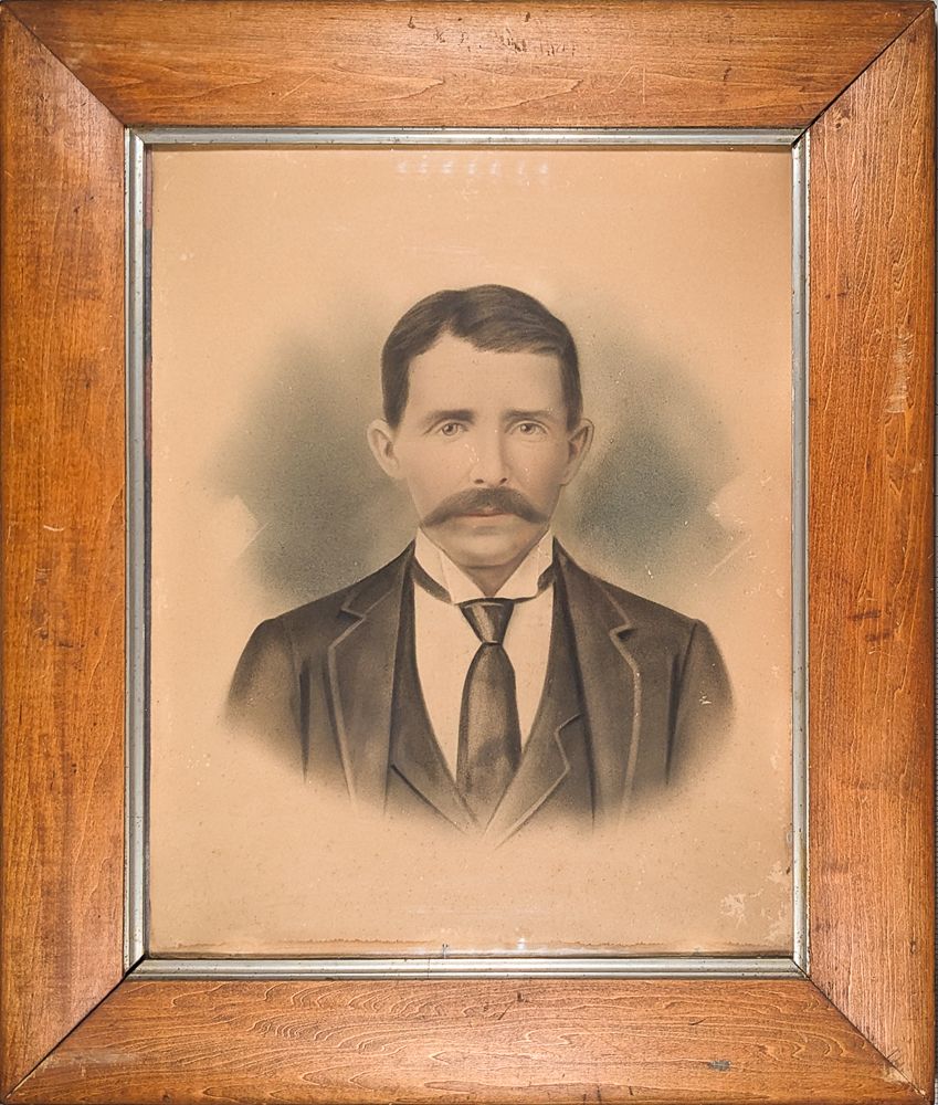 Antique portrait of a man with a large mustache in a simple frame