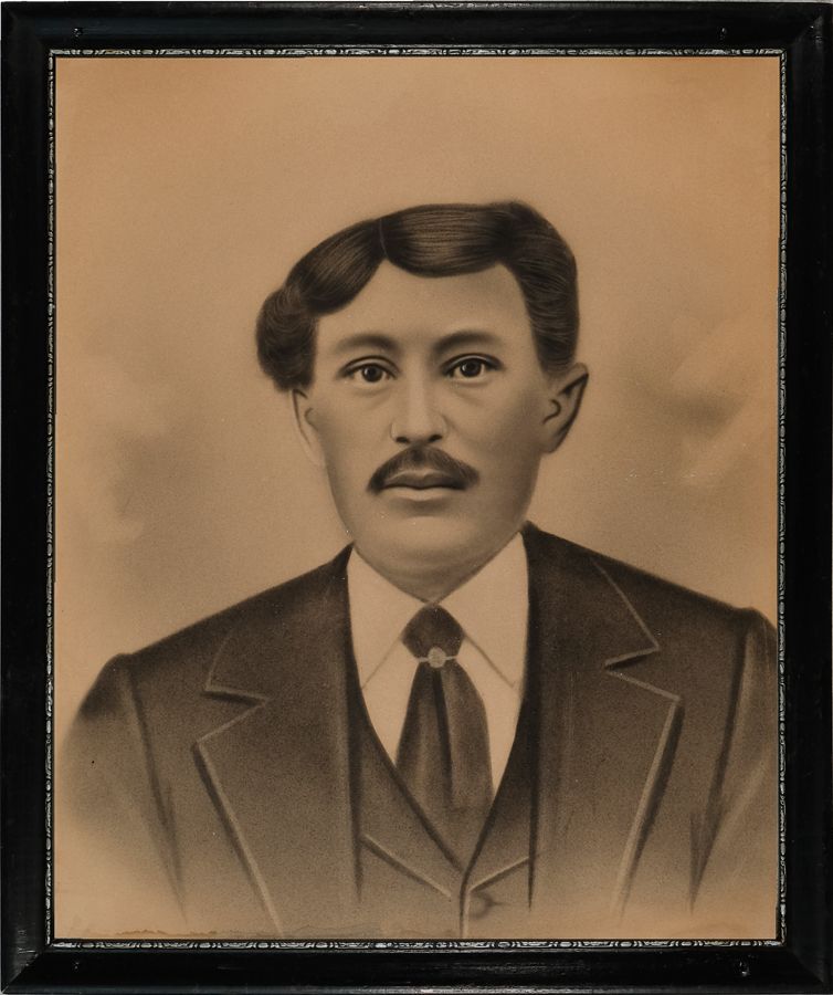 Antique sepia image of a man with lopsided hair and a mustache