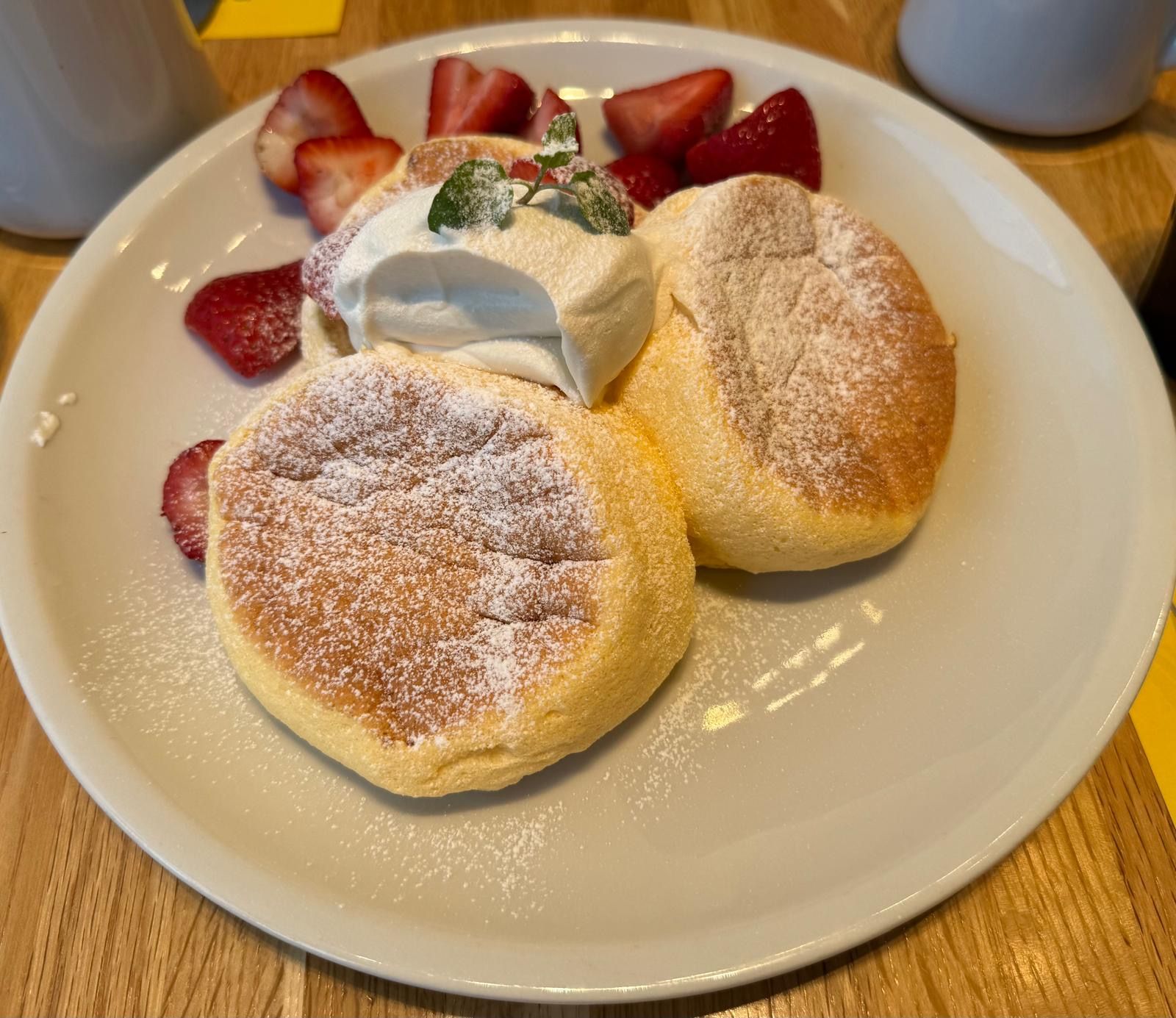 Pancakes with fresh cream and strawberries