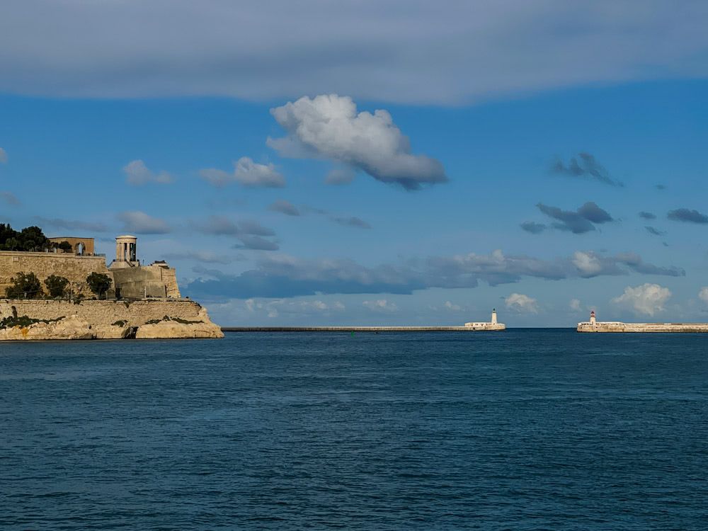 From left to right: Siege Bell Memorial, St. Elmo Breakwater Lighthouse, Ricasoli Breakwater Lighthouse