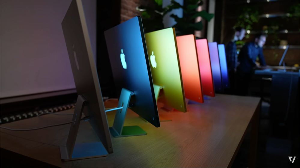 iMacs lined up on a table.