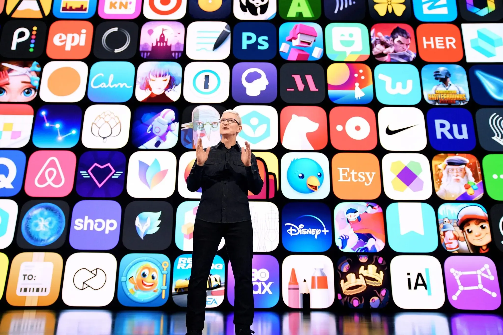 Tim Cook in front of a grid of app icons