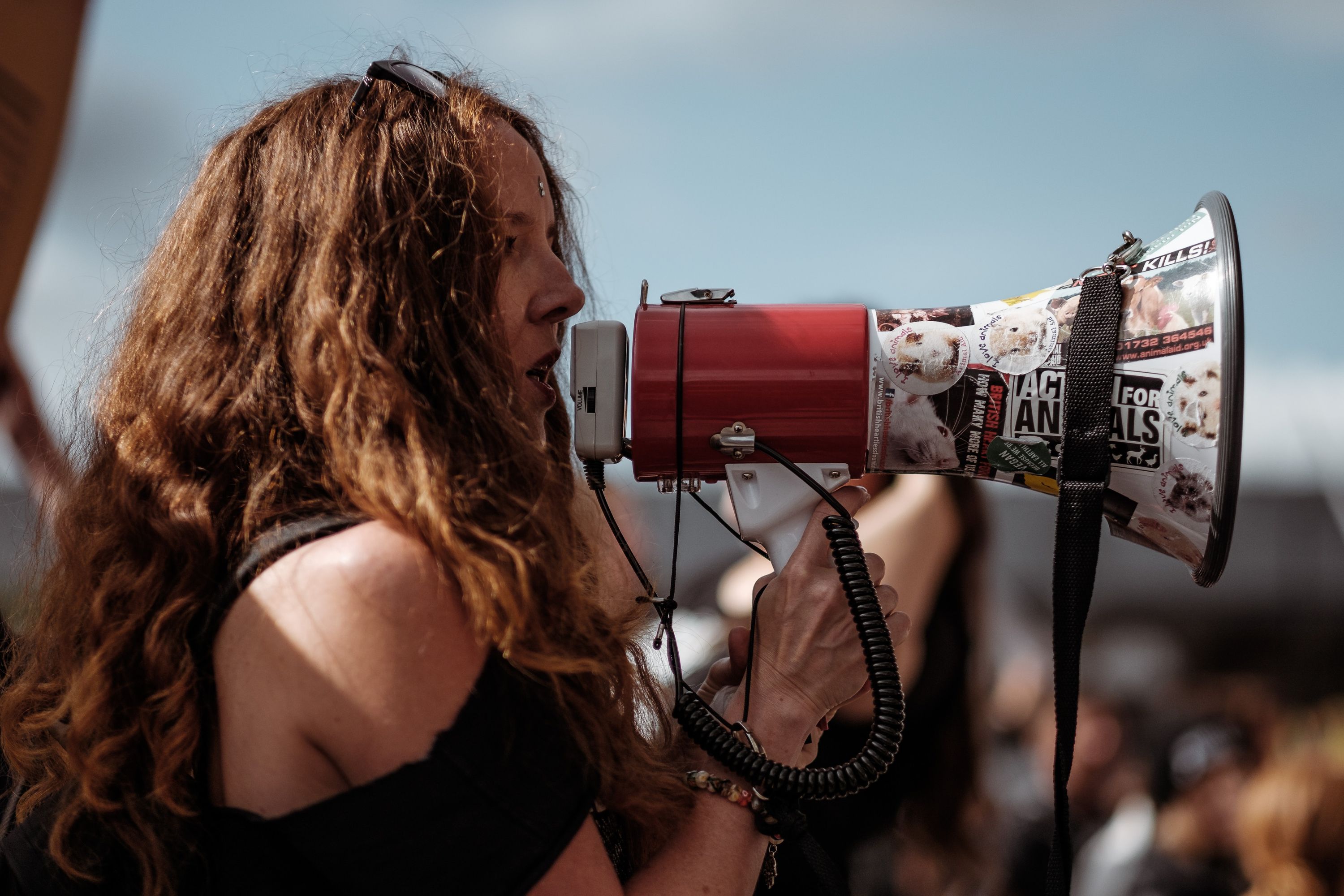 image of a woman wearing a black shirt and using a megaphone
